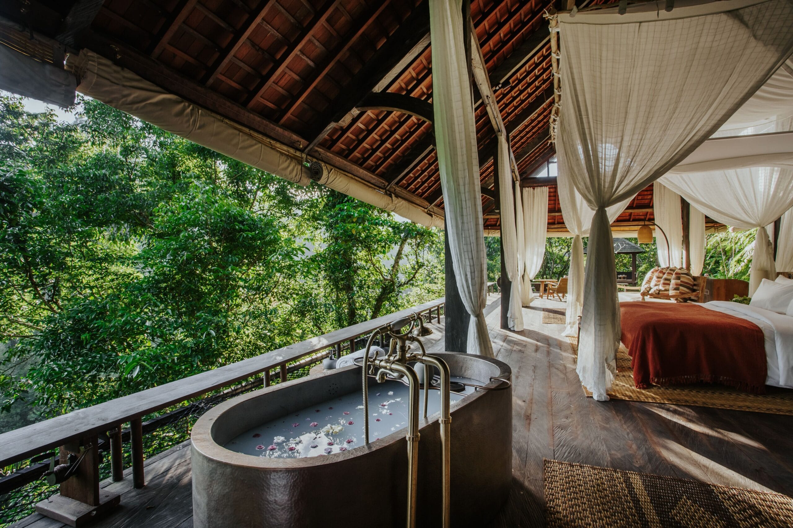 No-walls open-air bale interior with four-poster bed at Buahan, a Banyan Tree Escape in Bali