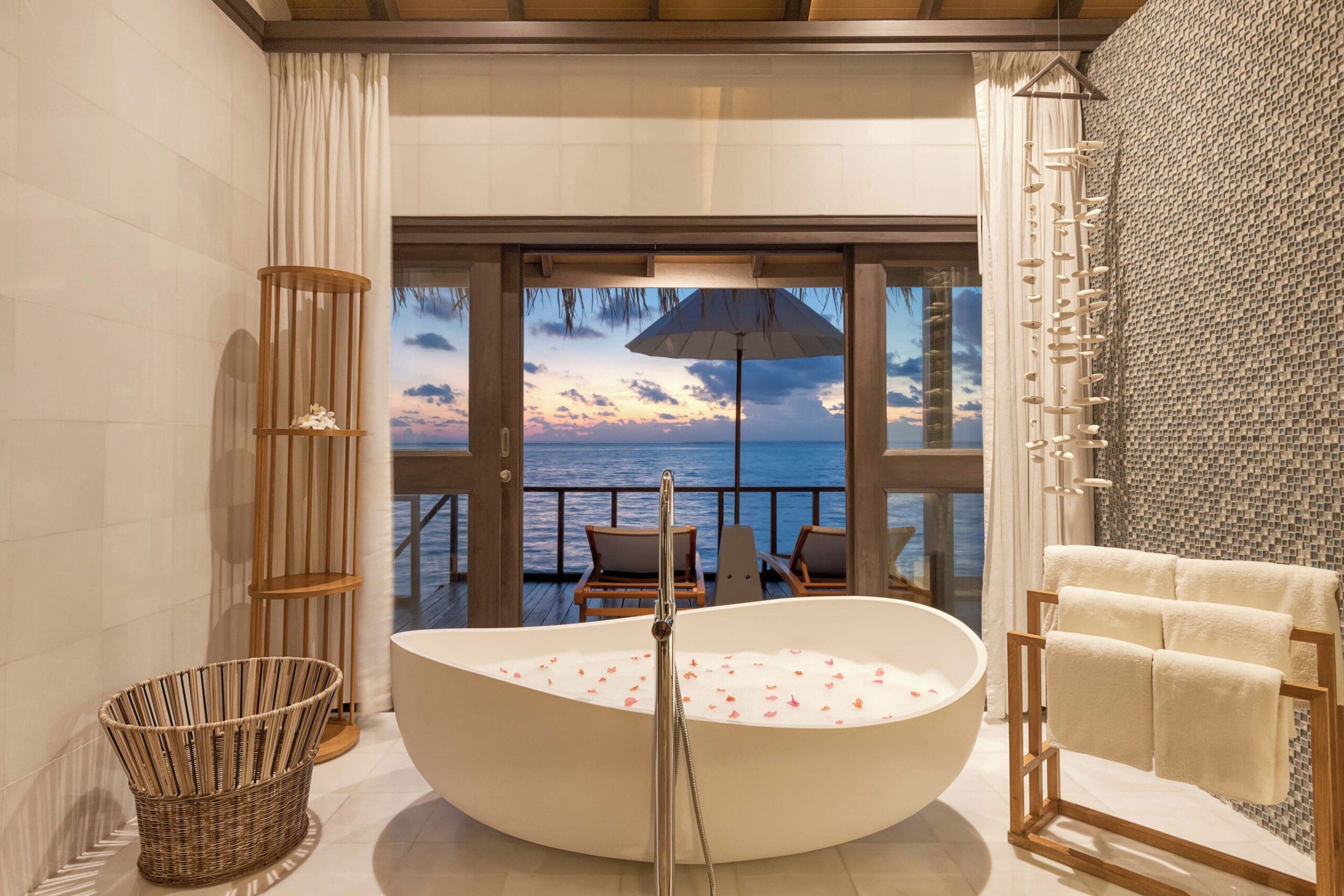 OZEN LIFE MAADHOO Maldives water villa interior with glass floor over the lagoon