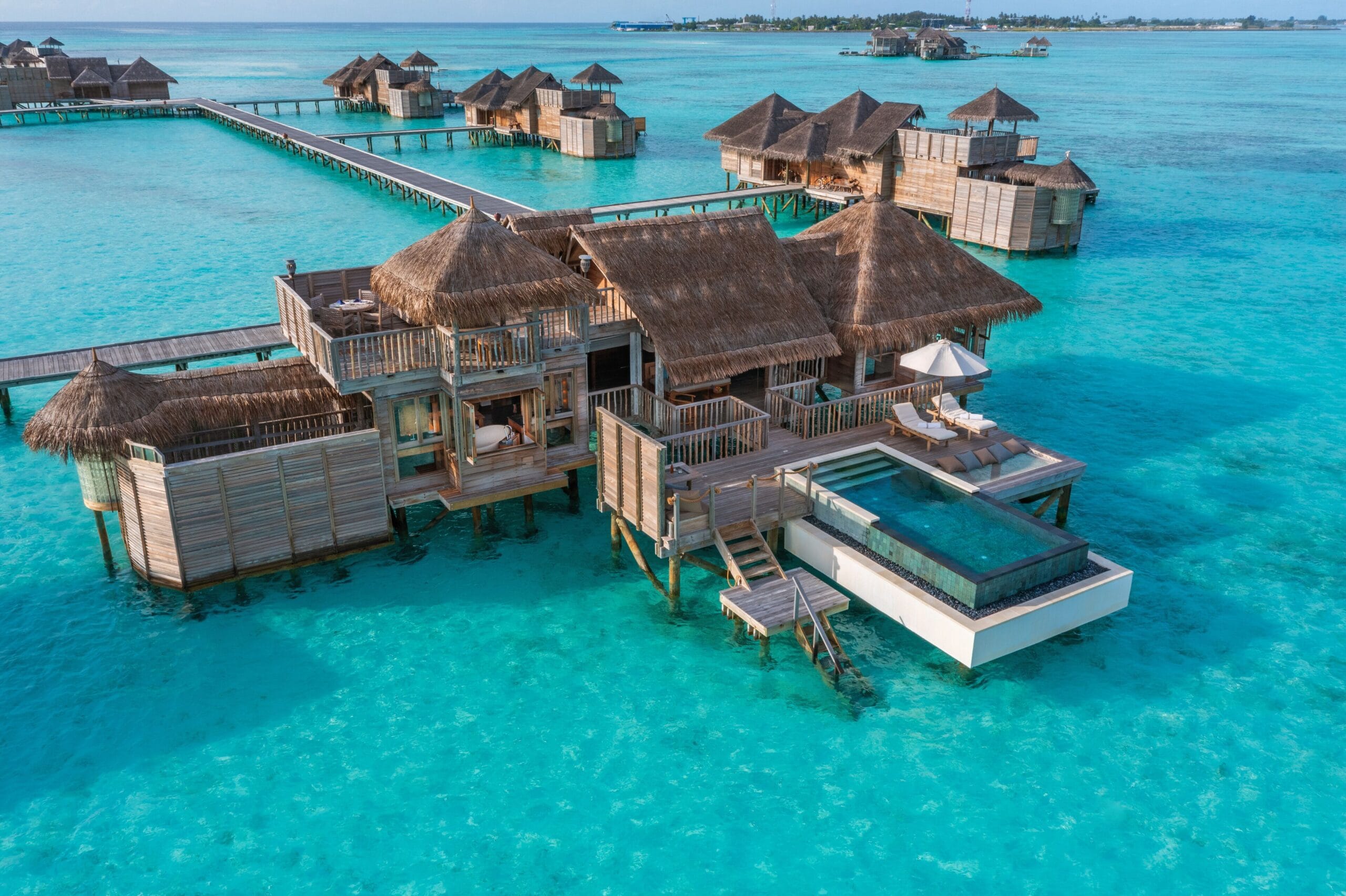 Thatched overwater villa with rooftop deck at Gili Lankanfushi, the original barefoot-luxury Maldives overwater bungalow