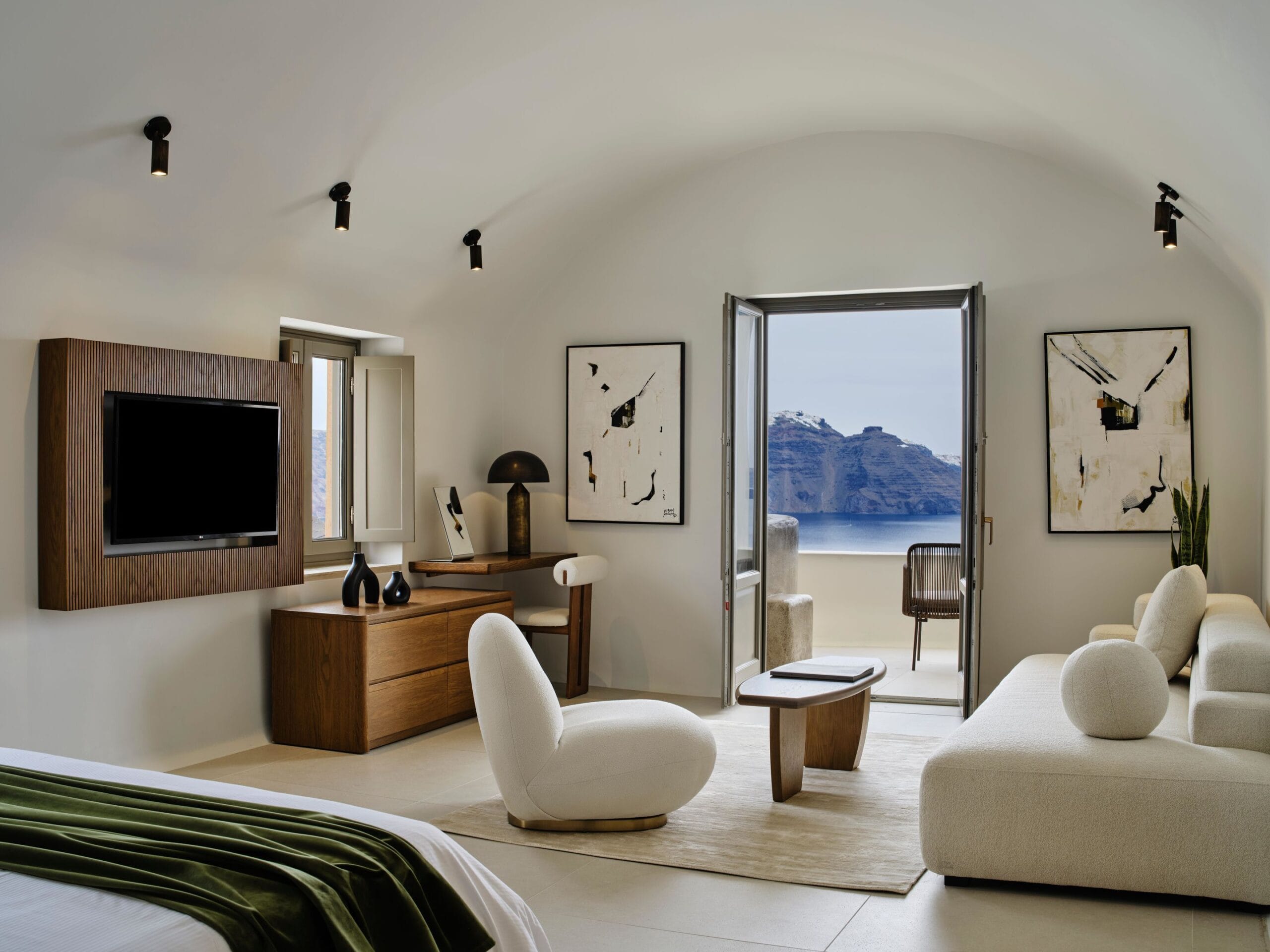 Andronis Luxury Suites cave suite interior carved into the Oia cliff with Cycladic design and caldera view
