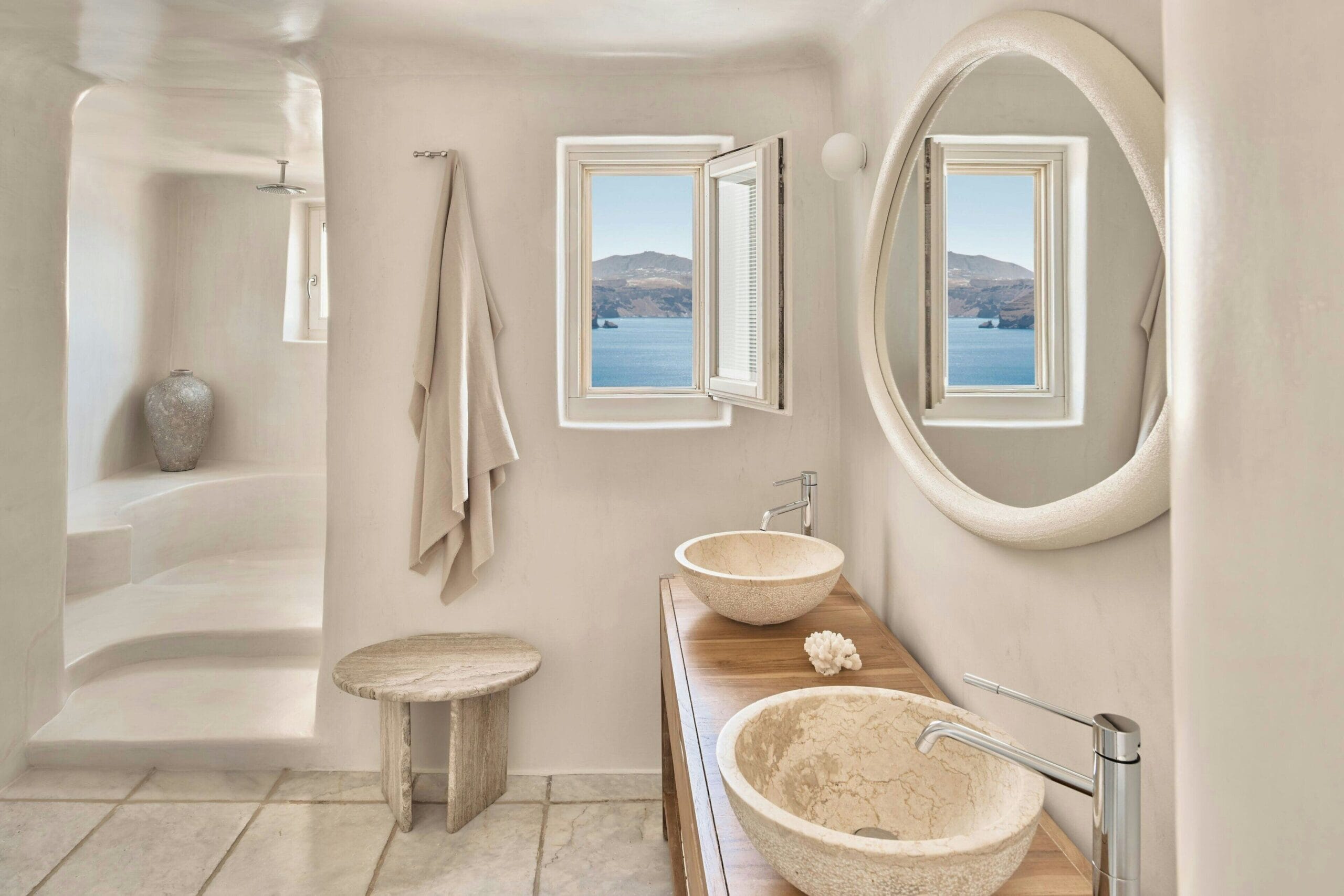 Mystique Santorini cave suite interior with Cycladic white-on-white design and caldera view in Oia