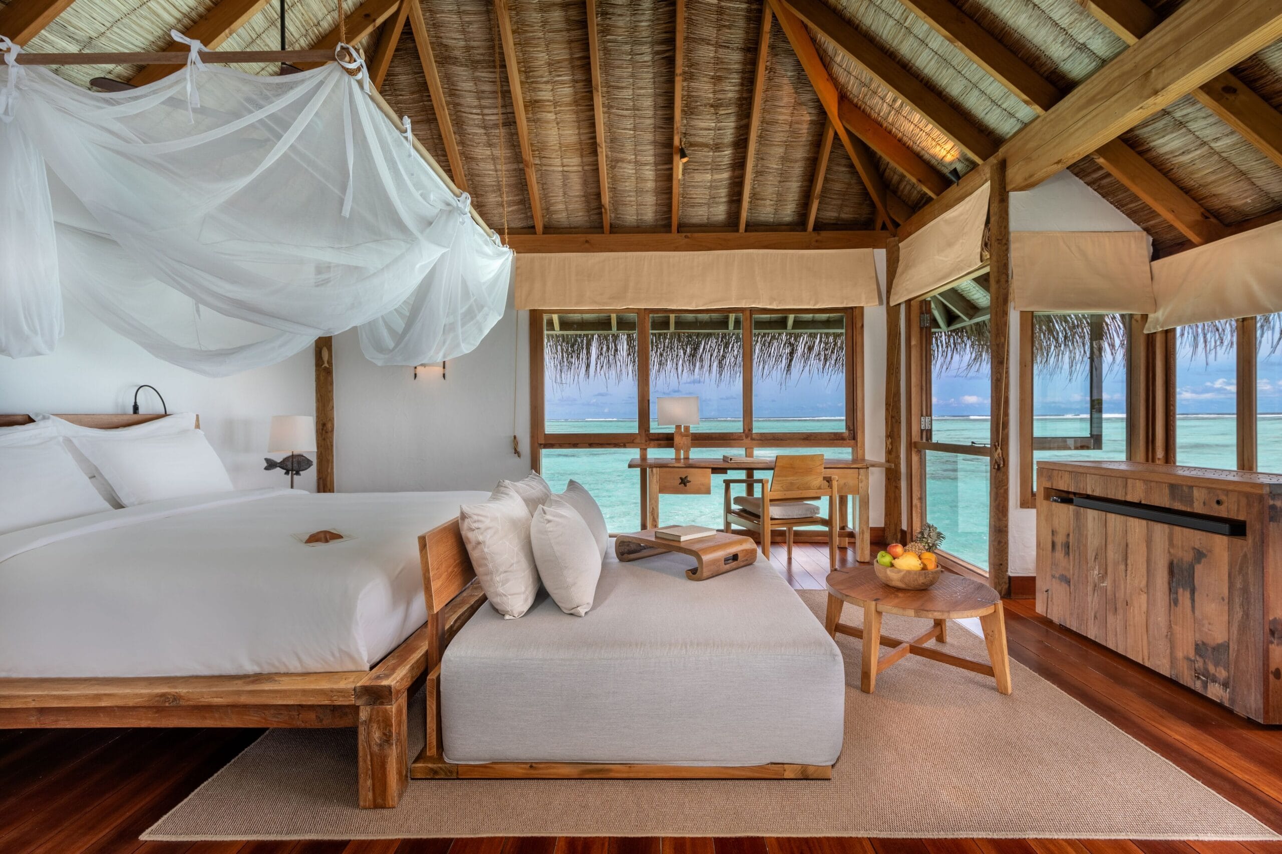 Gili Lankanfushi Maldives water villa interior in rustic natural materials over the lagoon