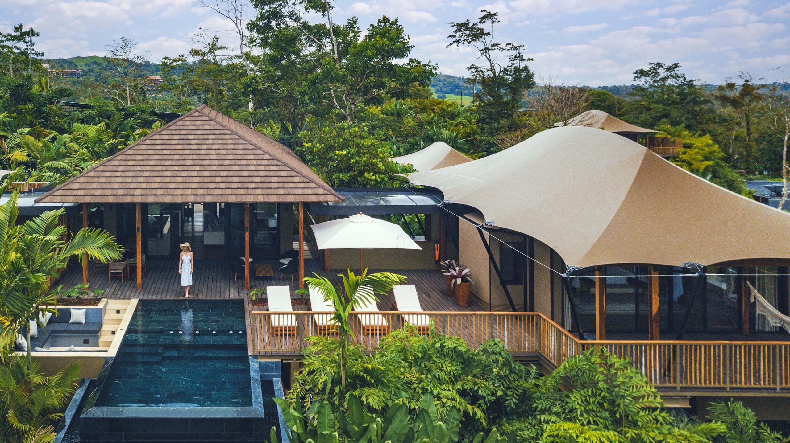 Luxury tent interior with four-poster canopy bed and rainforest views at Nayara Tented Camp, Arenal Costa Rica
