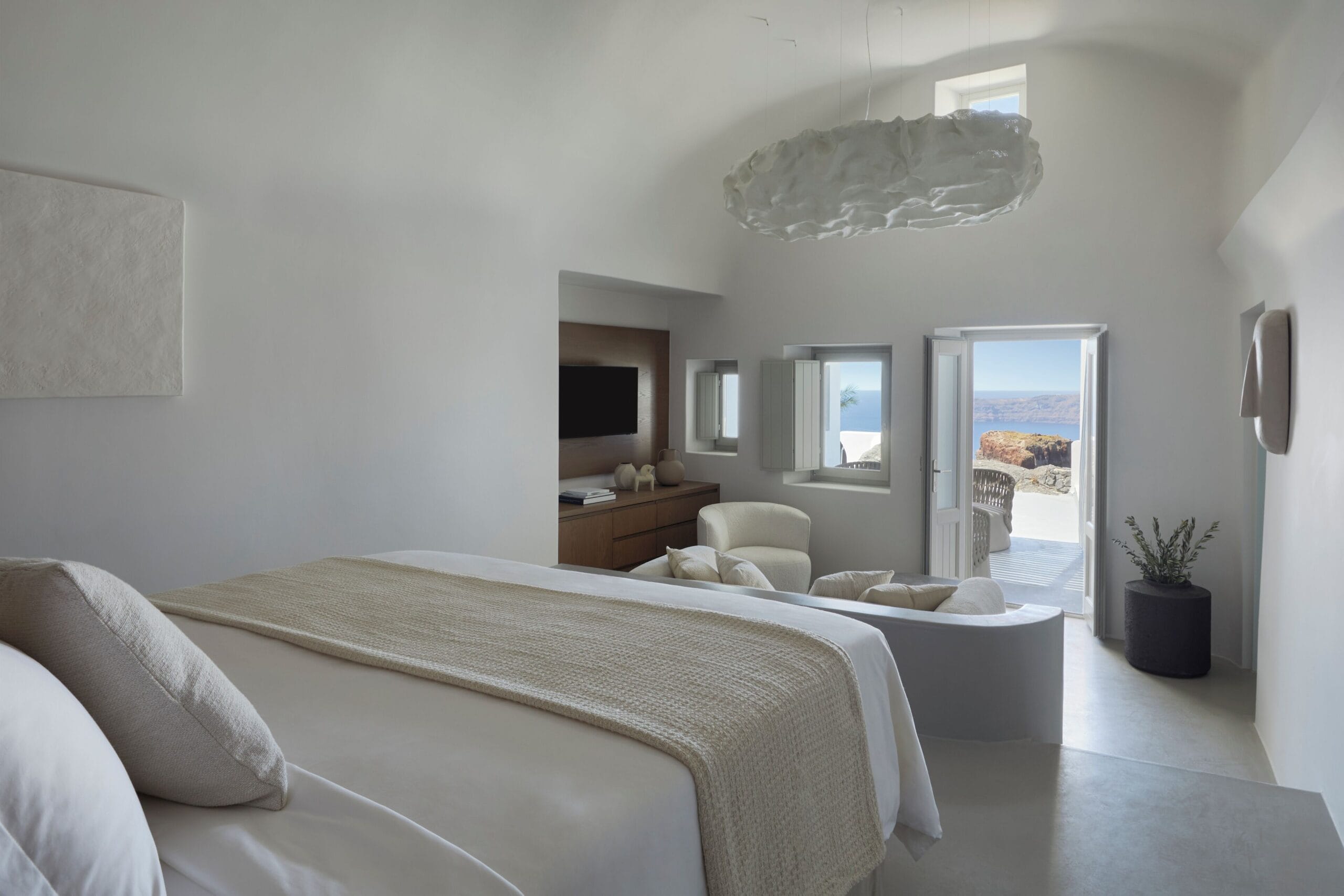 World-class infinity pool with panoramic caldera views at Grace Hotel Santorini, a top cave hotel in Imerovigli