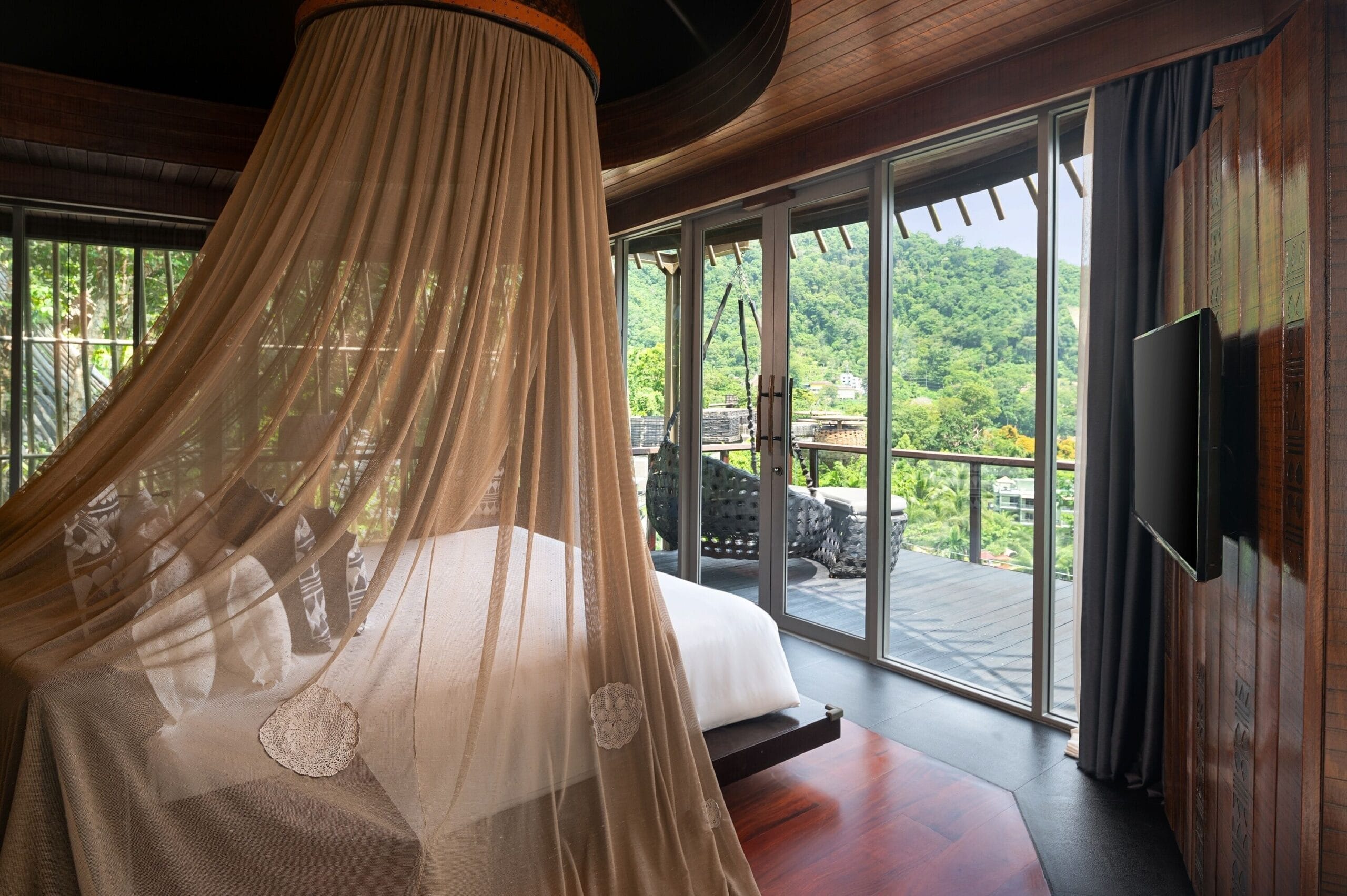 Bird's Nest villa interior with canopy bed and rainforest views at Keemala luxury treehouse hotel, Phuket Thailand