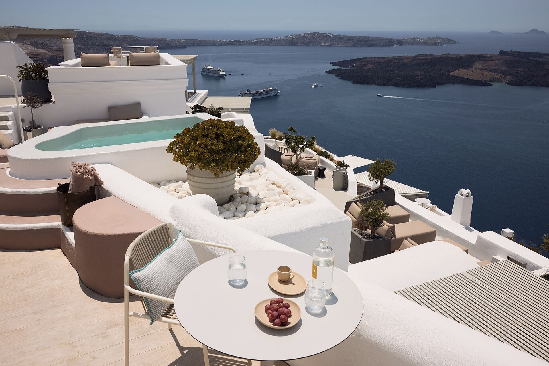 Heated infinity pool overlooking the volcano and caldera at Iconic Santorini in Imerovigli