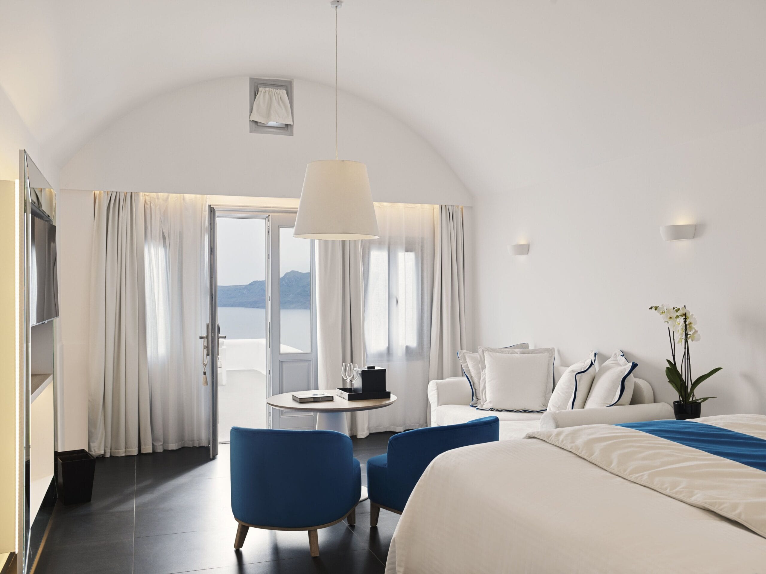 Katikies Santorini cave suite with arched Cycladic ceiling and caldera view in Oia