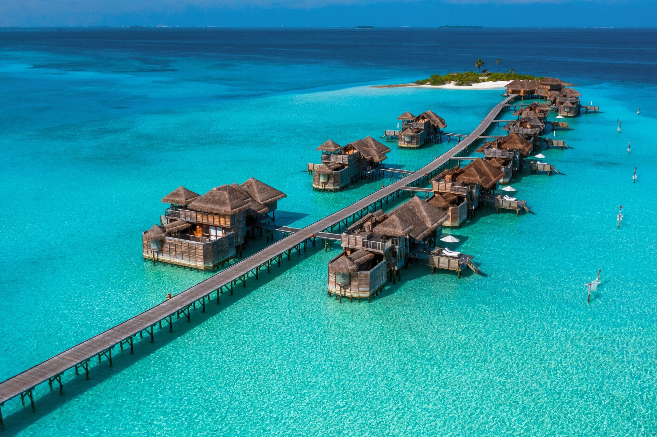 Gili Lankanfushi overwater villas and jetties over a crystal lagoon, an iconic Maldives water villa resort