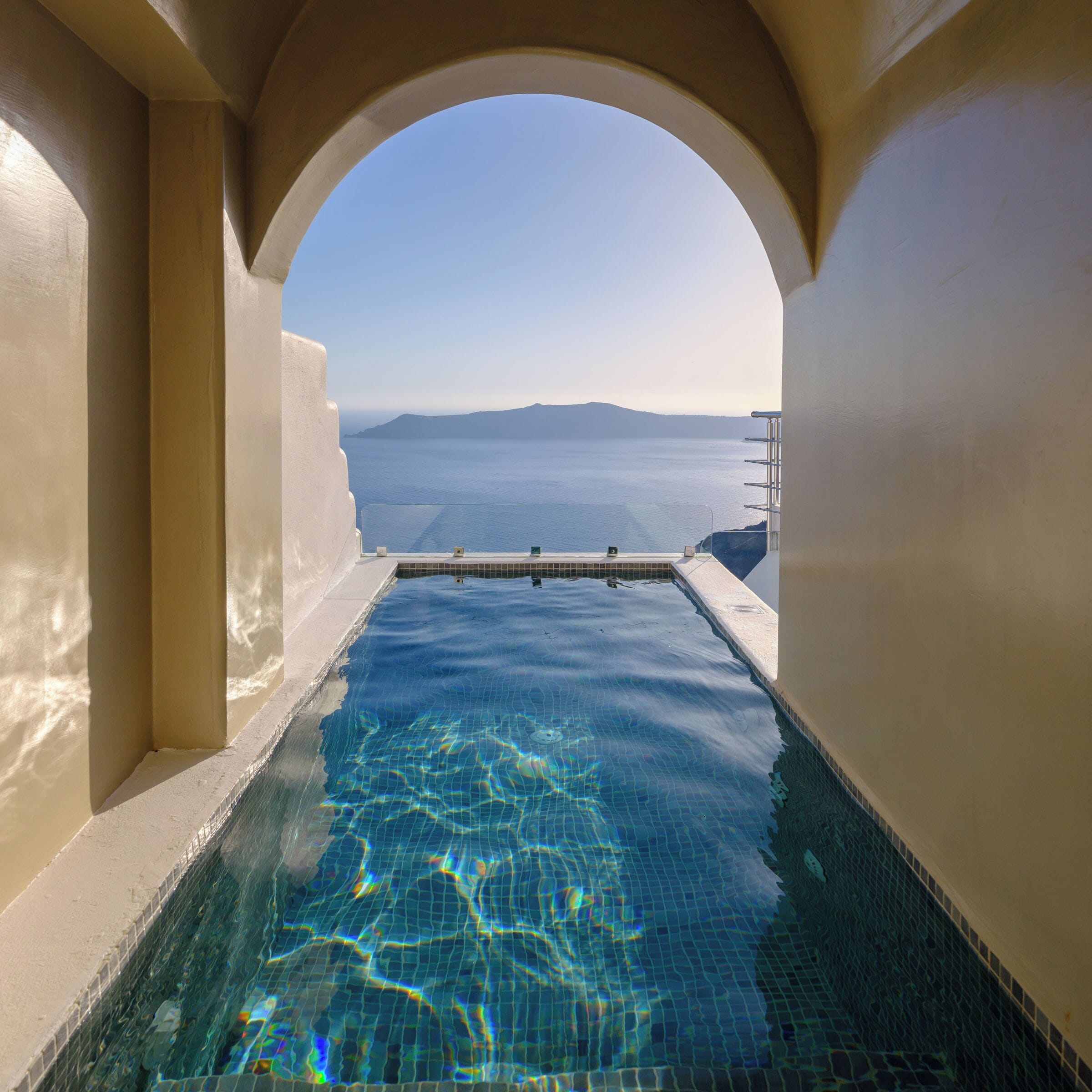 Whitewashed cave suite and terrace with caldera views at Pegasus Suites & Spa, a best-value cave hotel in Santorini