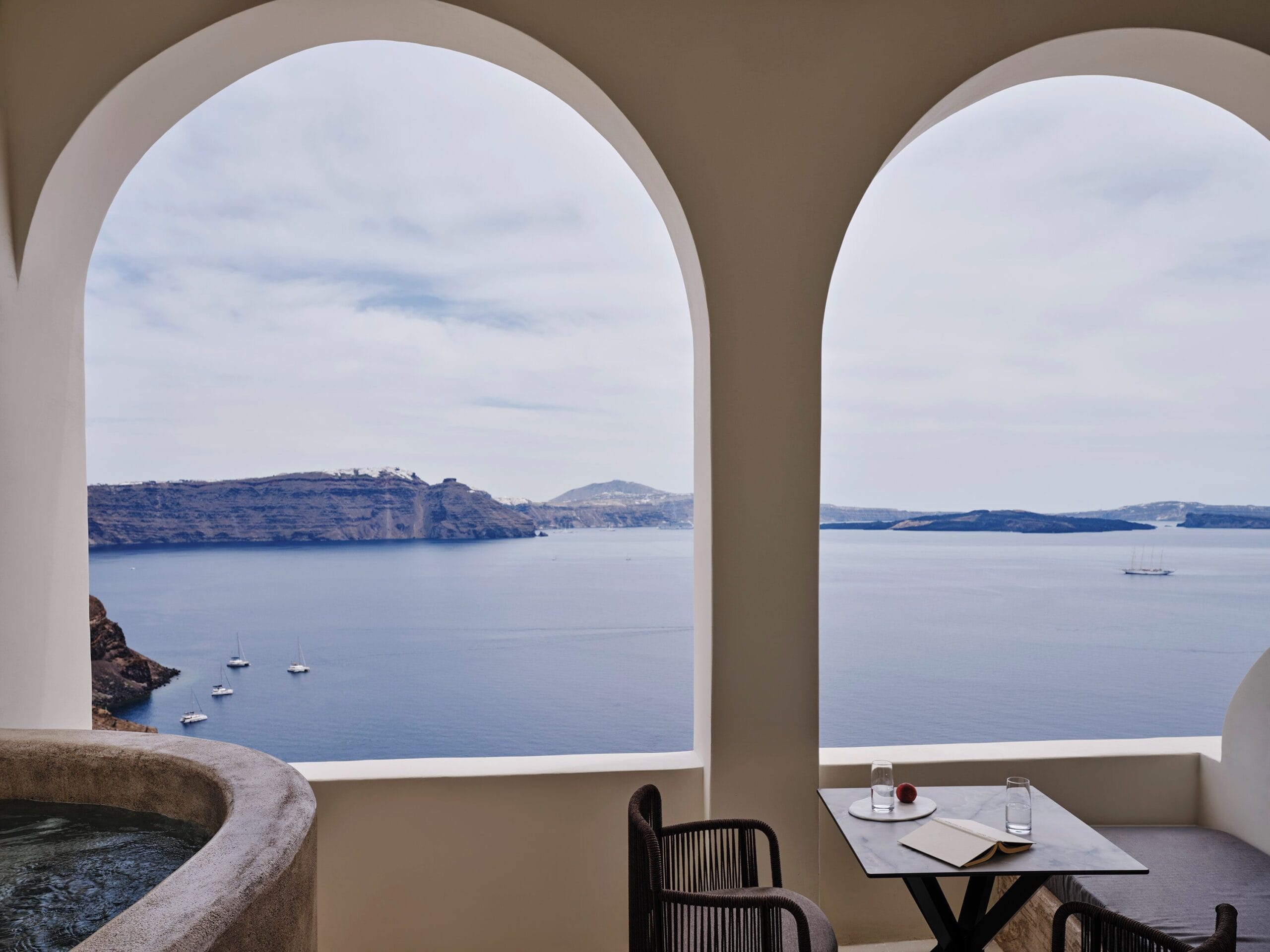 Private infinity pool terrace overlooking the Oia caldera and sunset at Andronis Luxury Suites, Santorini