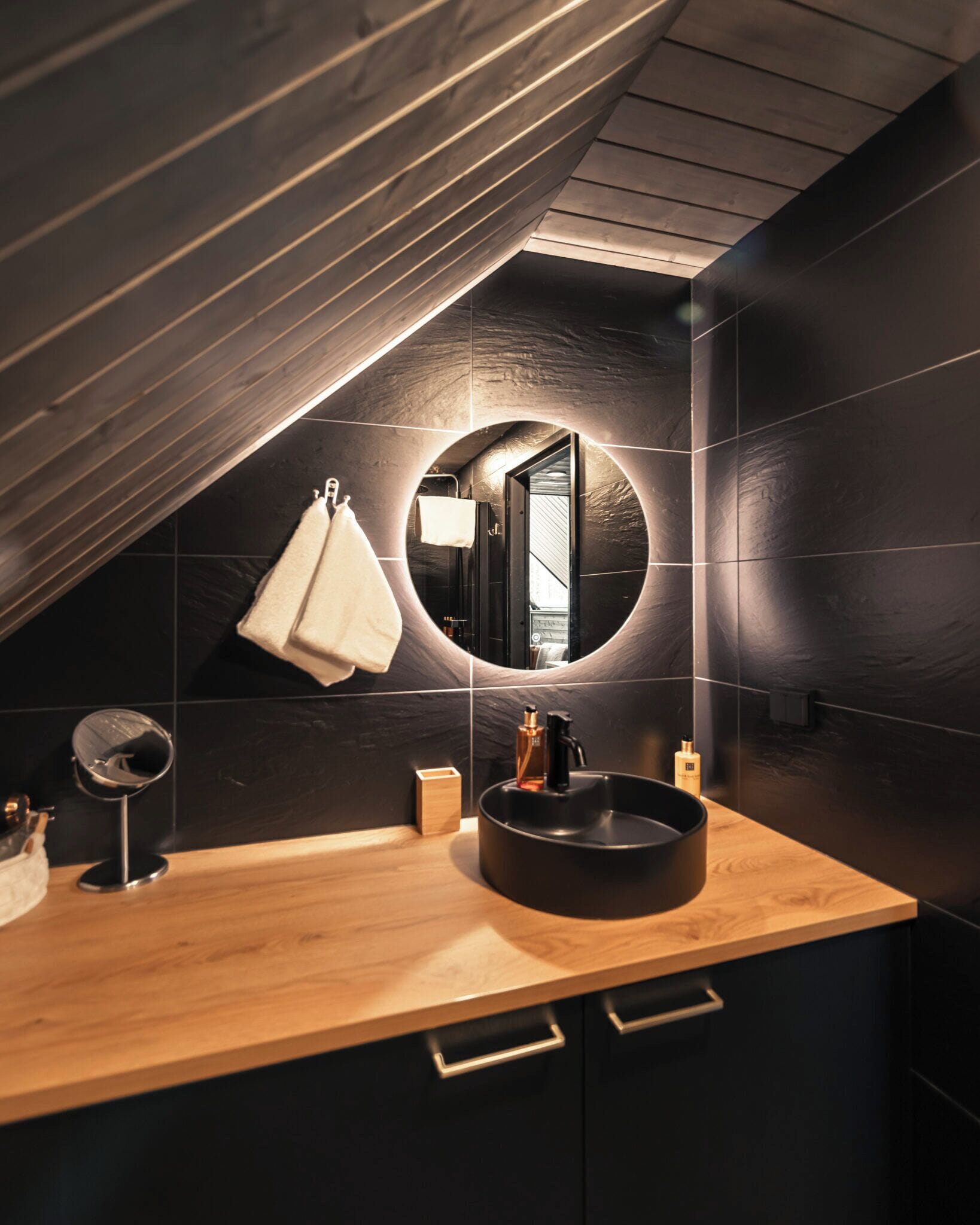 Private glass-roof cabins spread through snowy pine forest at Aurora Village Ivalo, far-north Lapland