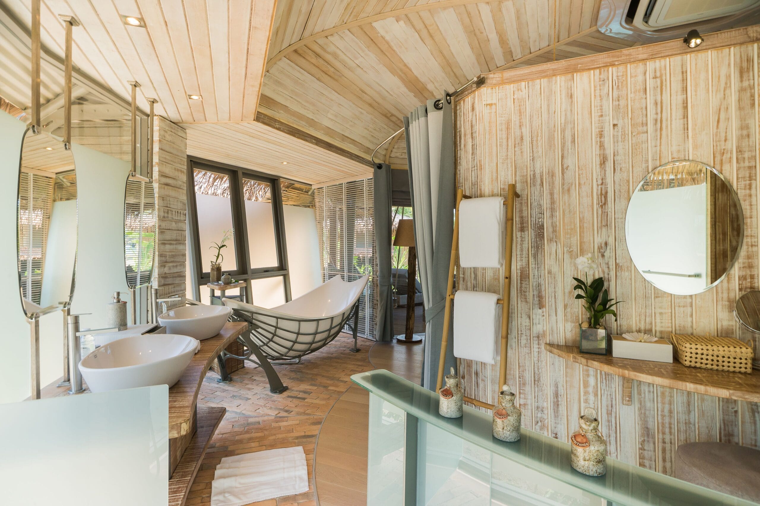 Open-air treehouse villa lower level with daybed and swing over the jungle at TreeHouse Villas Koh Yao Noi, Thailand