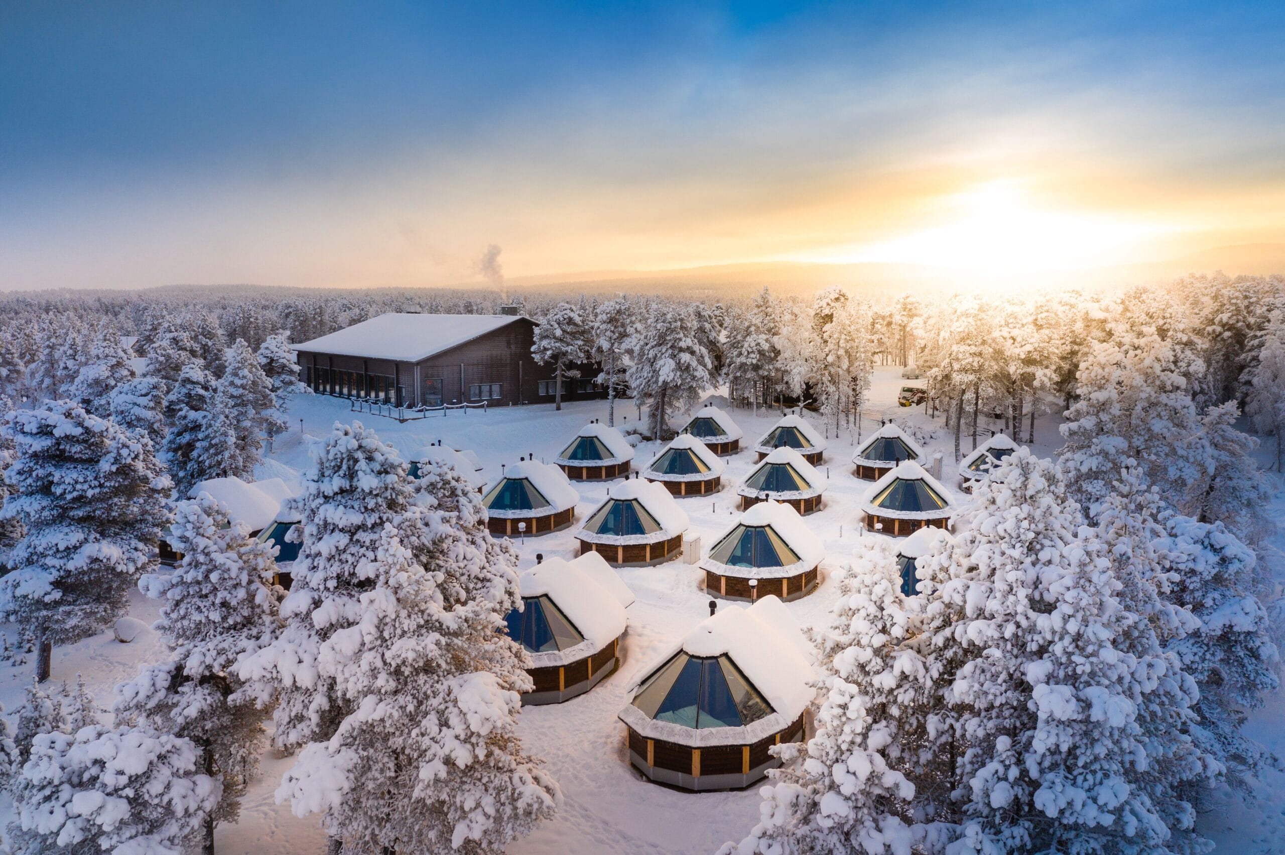 Glass-roof Aurora Cabin on the shore of Lake Inari under the Northern Lights at Wilderness Hotel Inari, far-north Finland