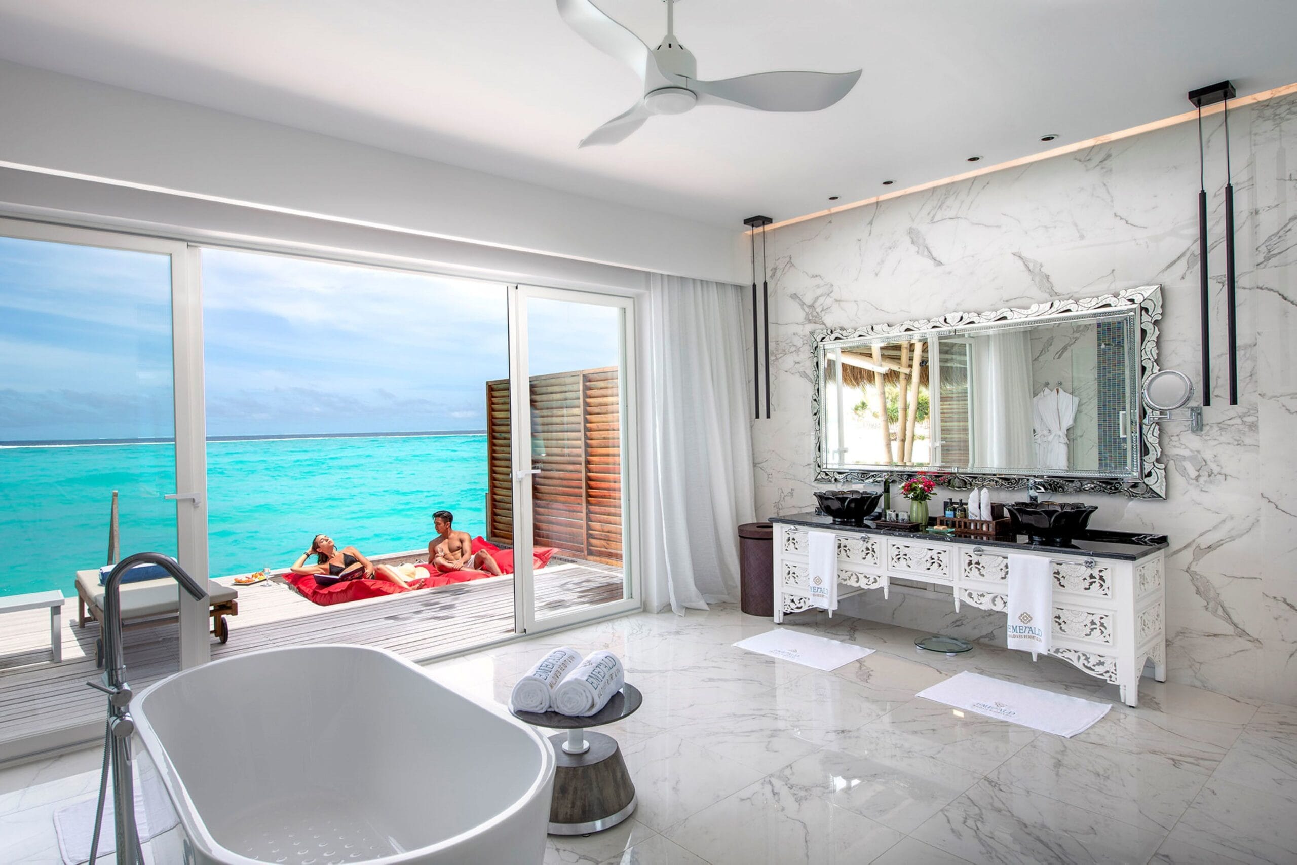 Emerald Maldives water villa interior with contemporary tropical design
