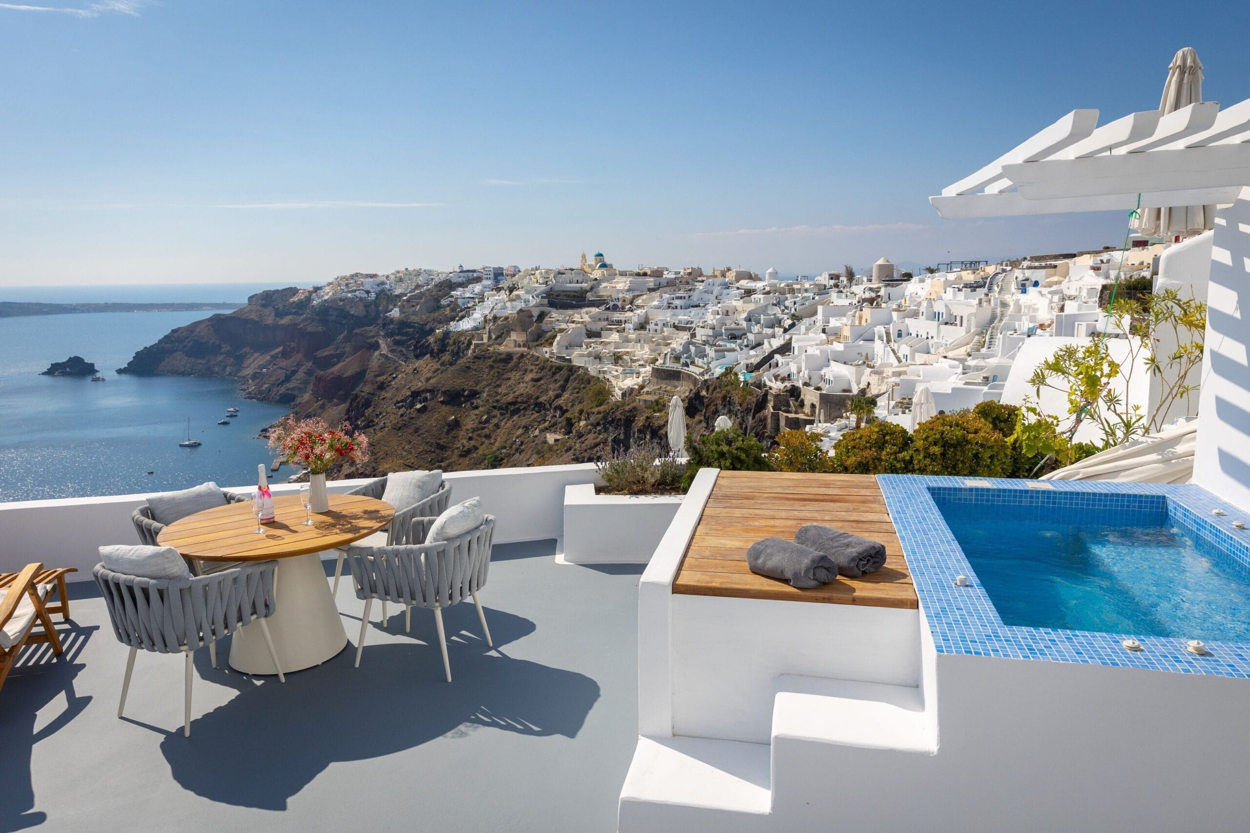 Cliffside infinity pool overlooking the caldera at sunset at Katikies Santorini in Oia