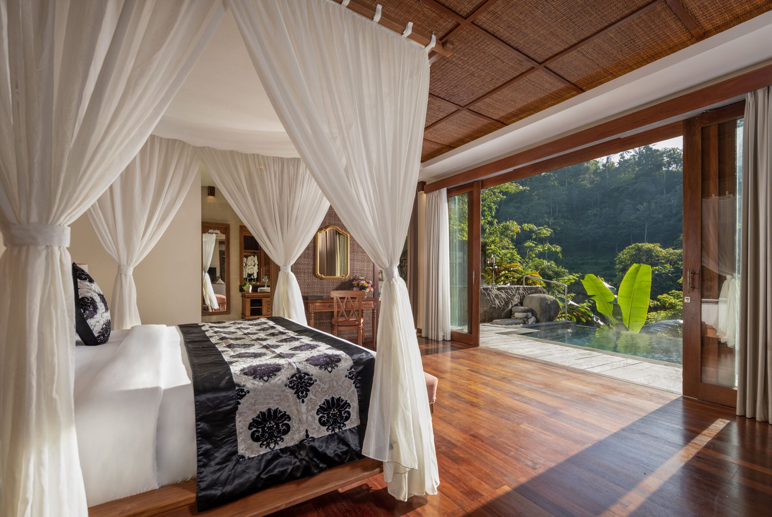 The Kayon Jungle Resort villa interior and terrace overlooking the Bali rainforest valley