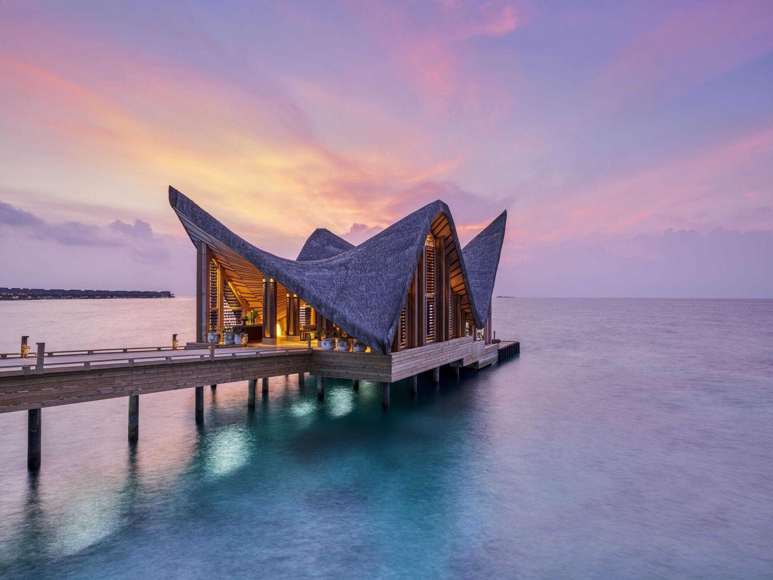 JOALI Maldives water villa interior with bespoke art and infinity pool over the lagoon