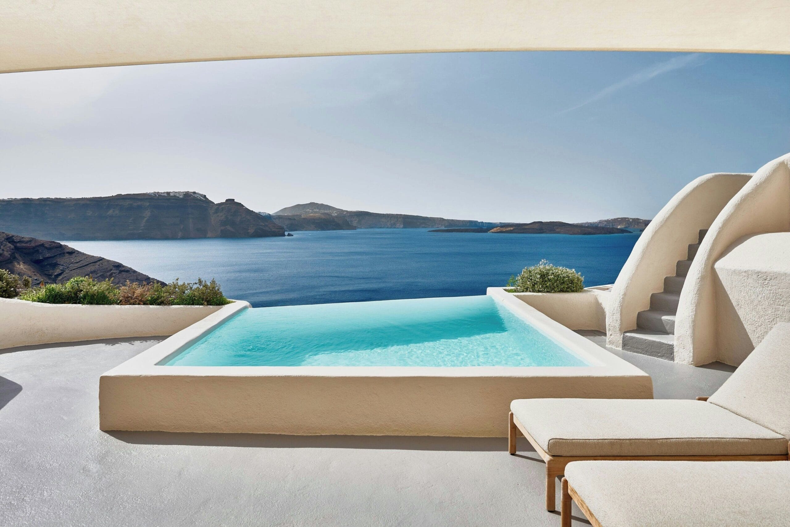 White-on-white cave suites and caldera views at Mystique, a Luxury Collection cave hotel in Oia Santorini