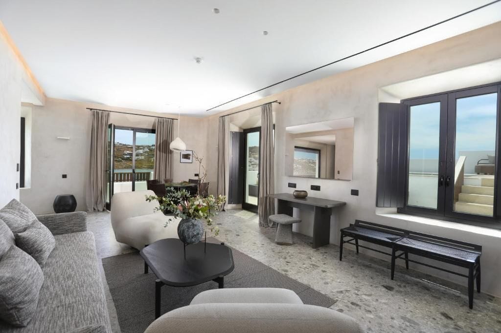 Minimalist marble and oak suite interior at Aeonic Suites and Spa, Mykonos