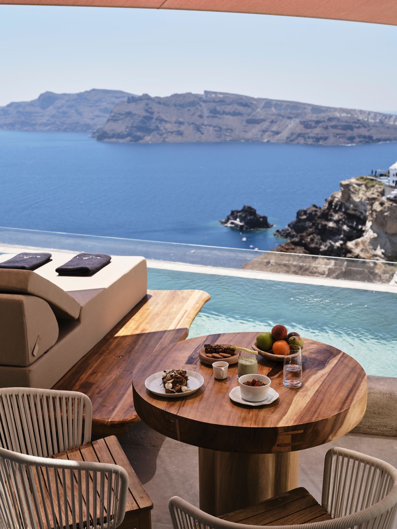 Private pool terrace at Andronis Luxury Suites with sunset views over Oia