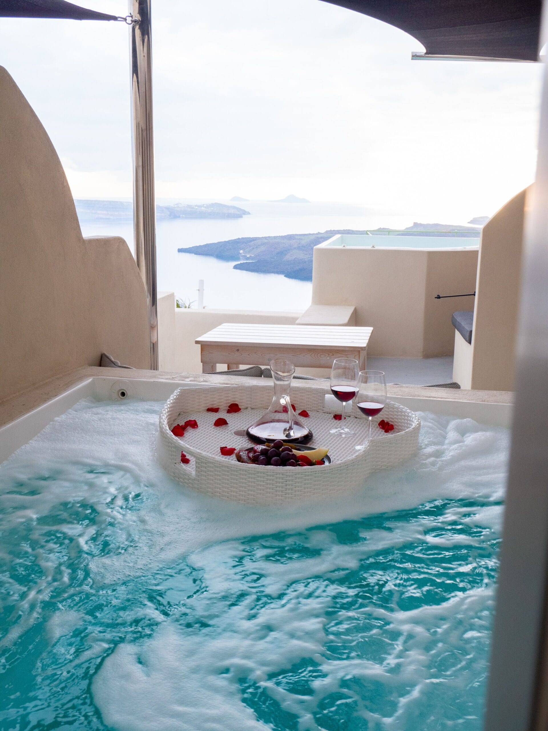Terrace jacuzzi hot tub with a caldera view at a Santorini suite