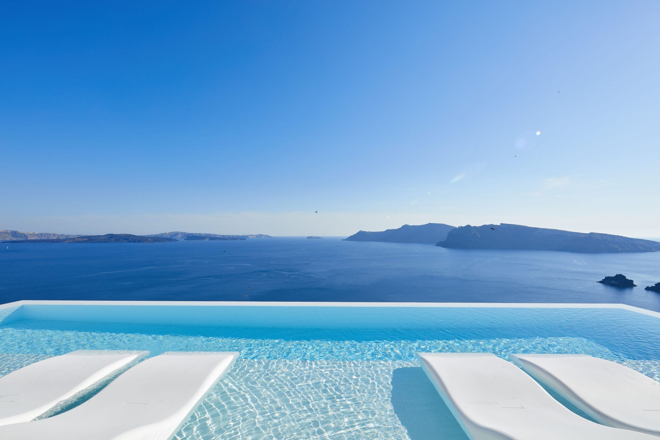 Infinity-edge pool with caldera and sea views at Canaves Oia Suites, Santorini