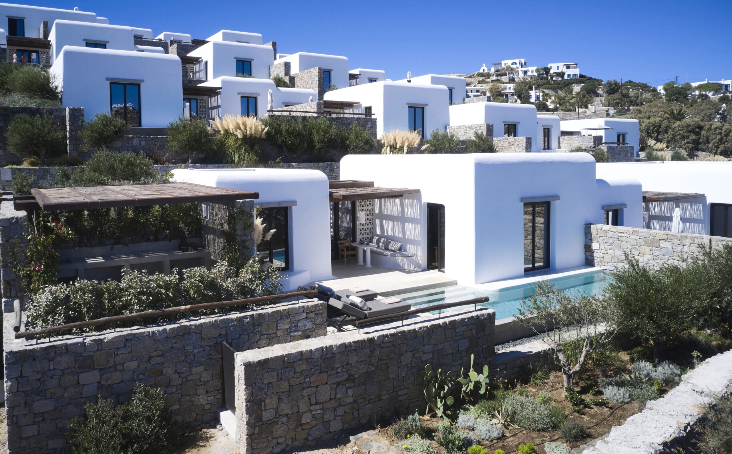 Cluster of whitewashed luxury villas each with a private pool at Kalesma Mykonos