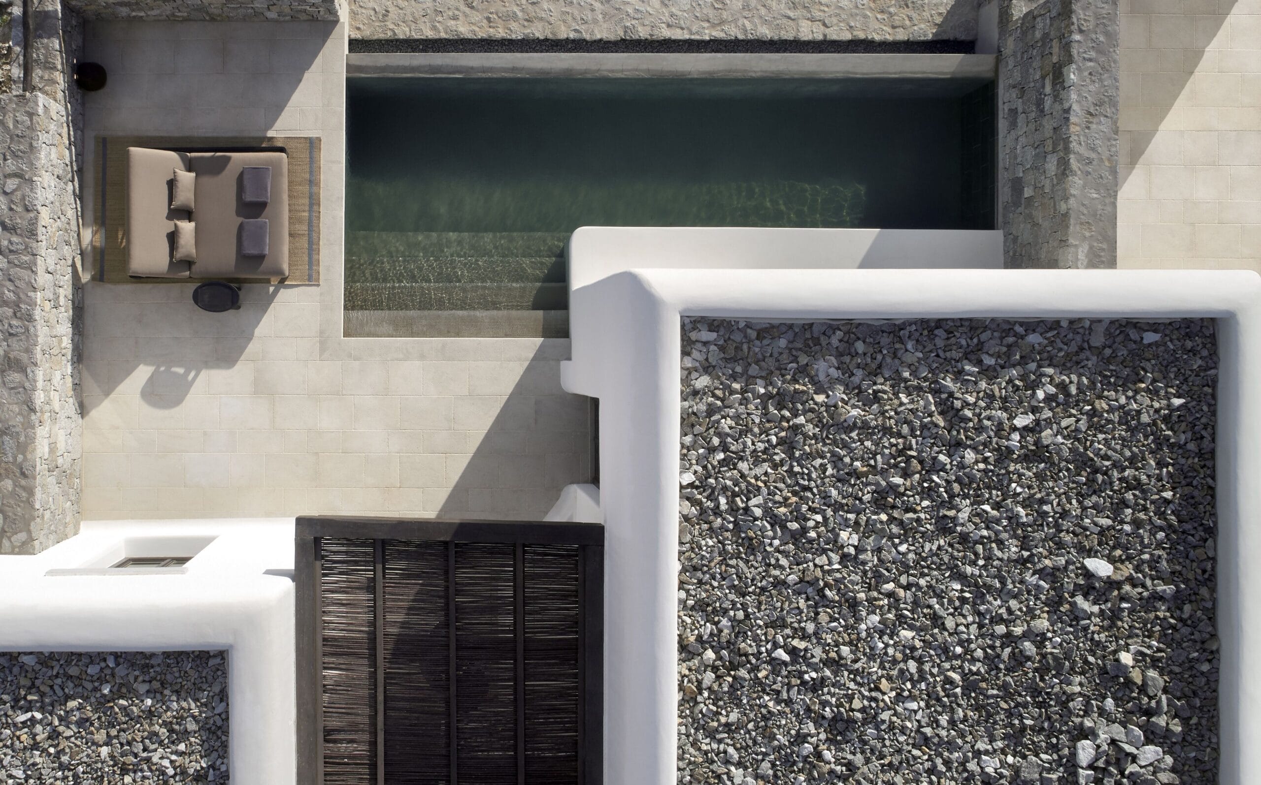 Aerial view of a whitewashed private pool villa at Kalesma Mykonos
