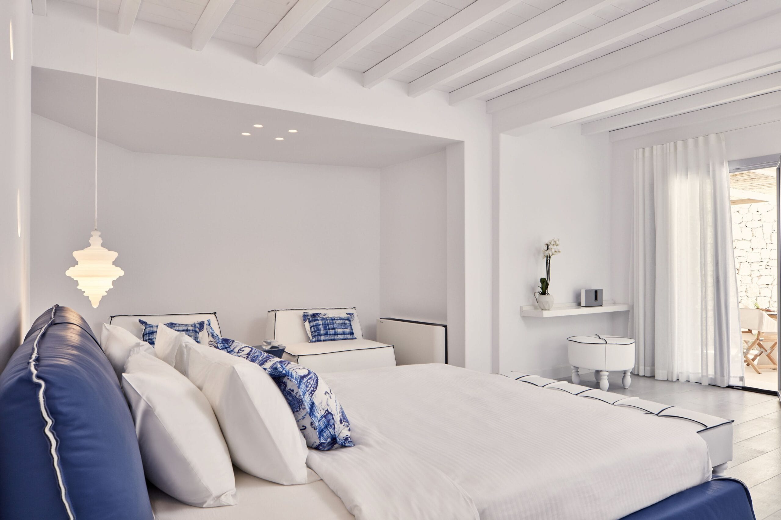 Minimalist white luxury suite bedroom at Katikies Mykonos