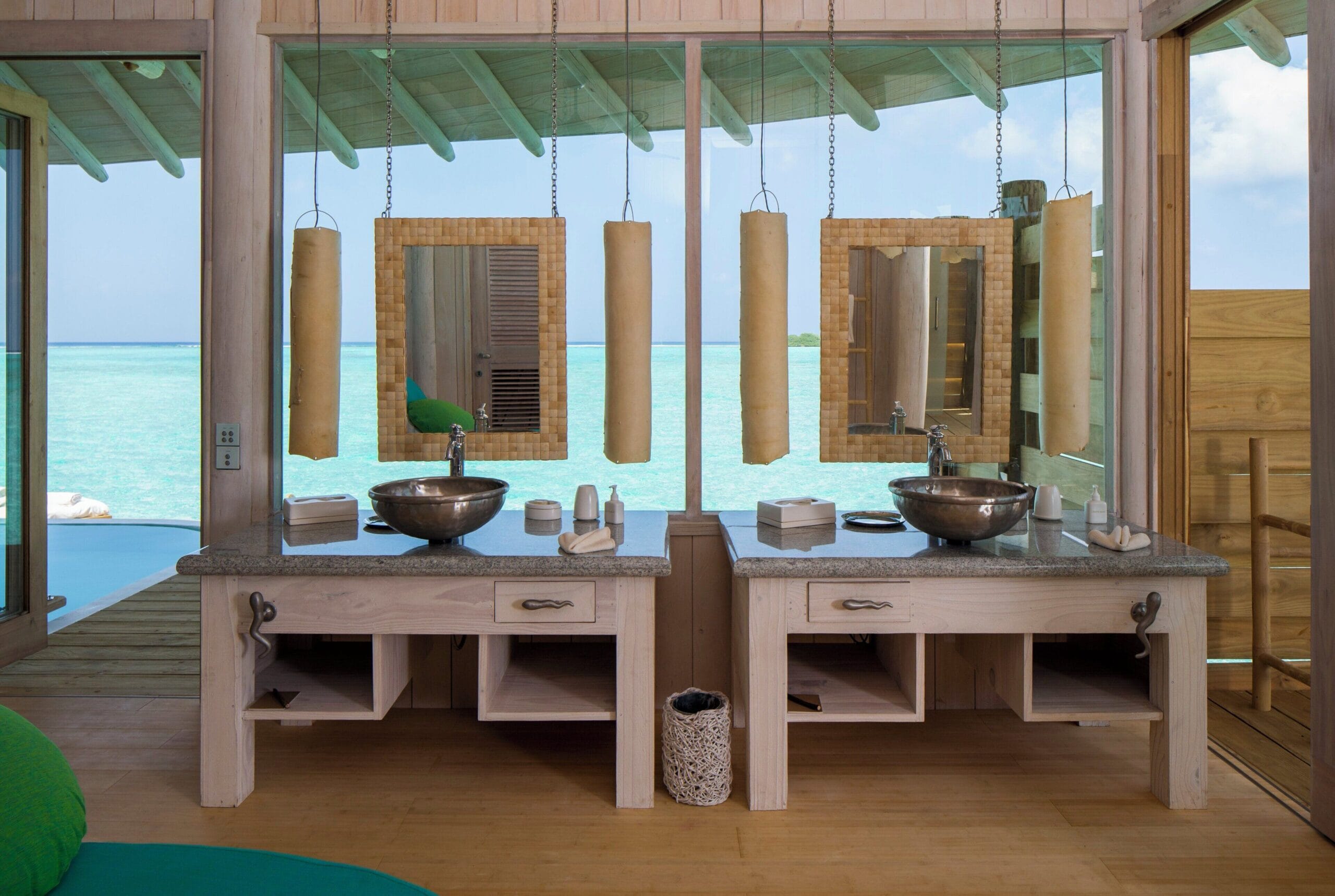 Ocean-view overwater bathroom opening to the lagoon at Soneva Jani, Maldives