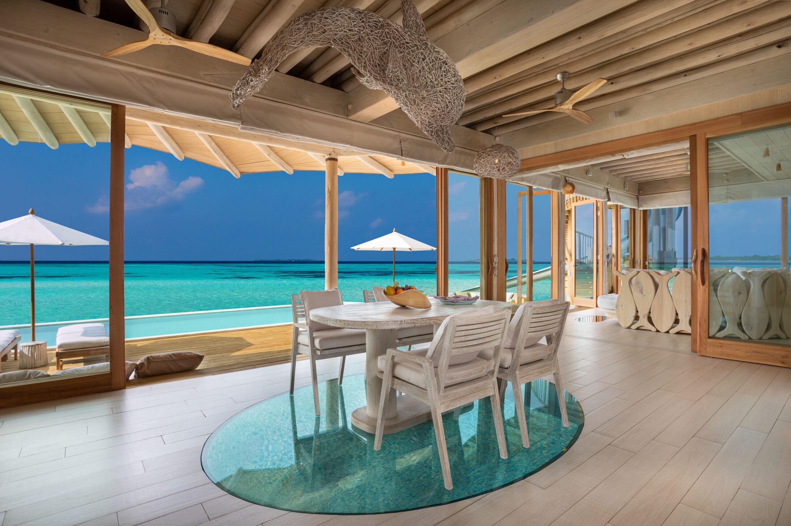 Open-air overwater living and dining area at Soneva Jani, Maldives