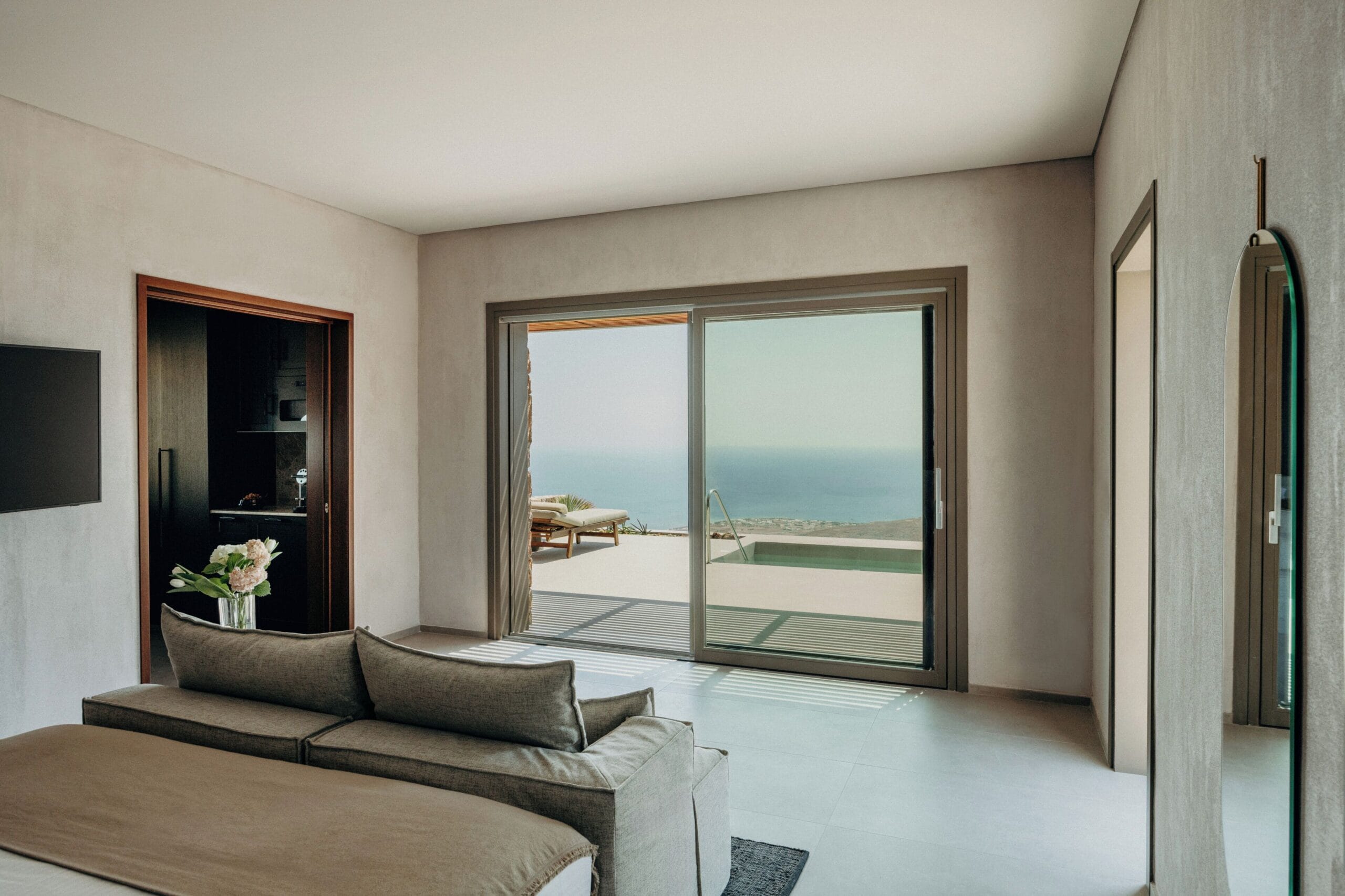 Santorini Sky villa interior opening onto its private pool and terrace