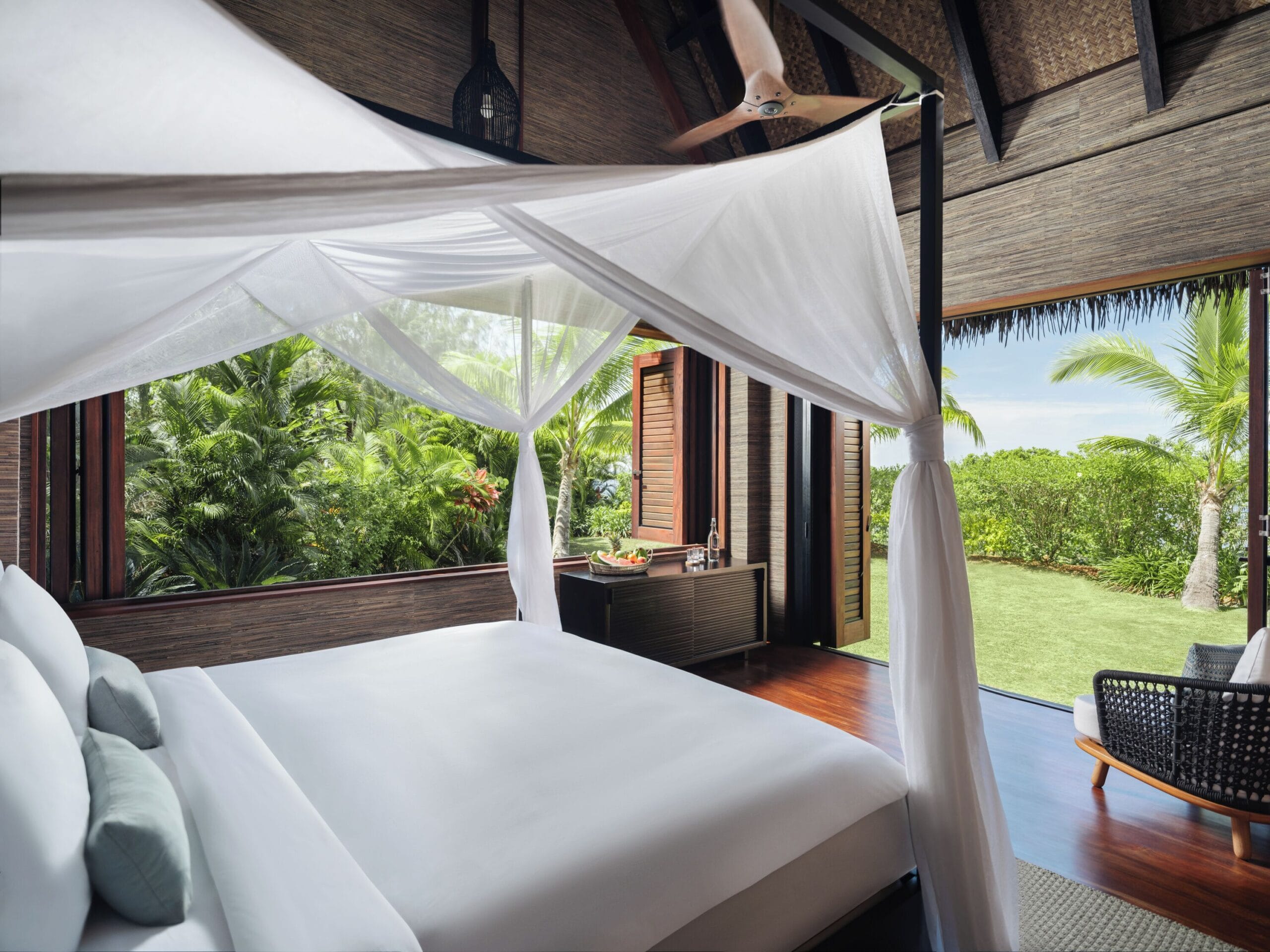 Light-filled luxury villa bedroom with island views at Six Senses Fiji