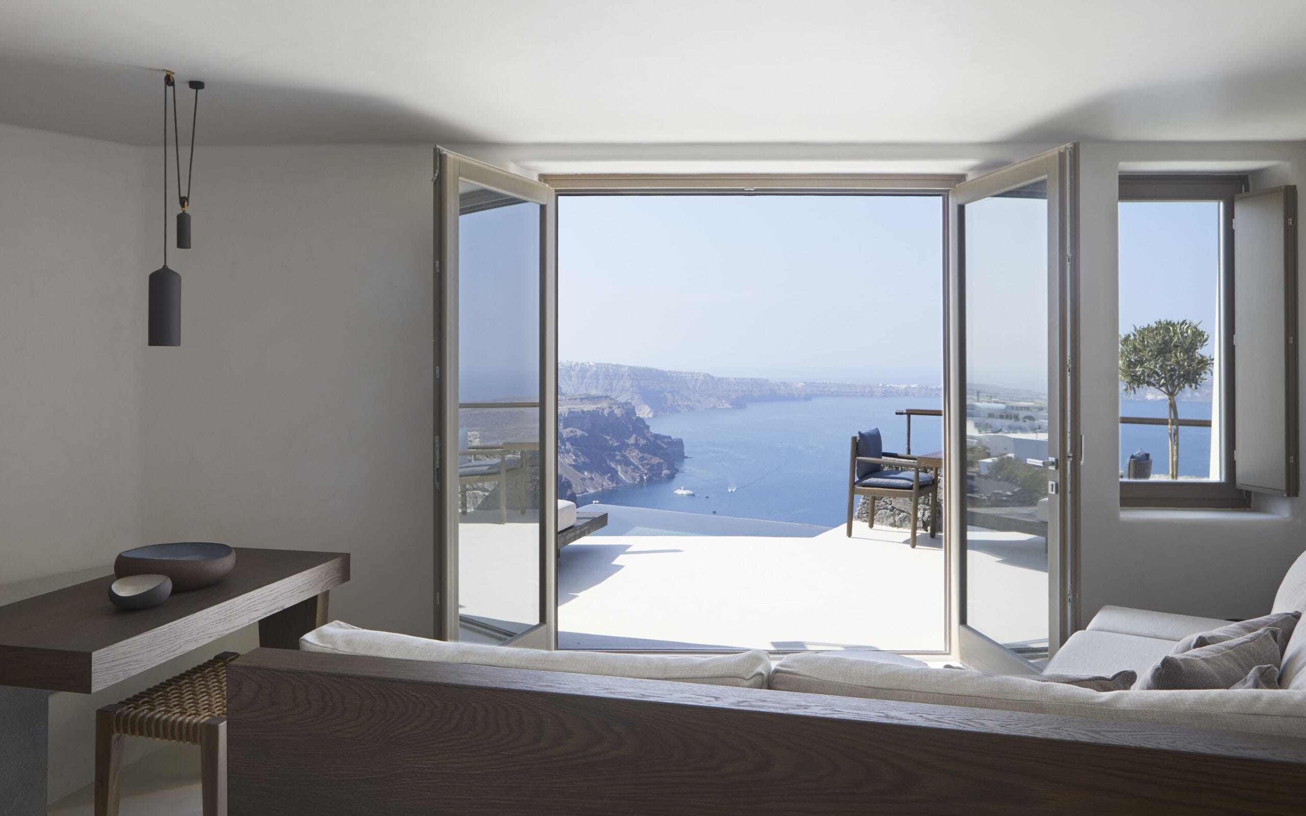 Minimalist Vora Santorini luxury villa interior with caldera view