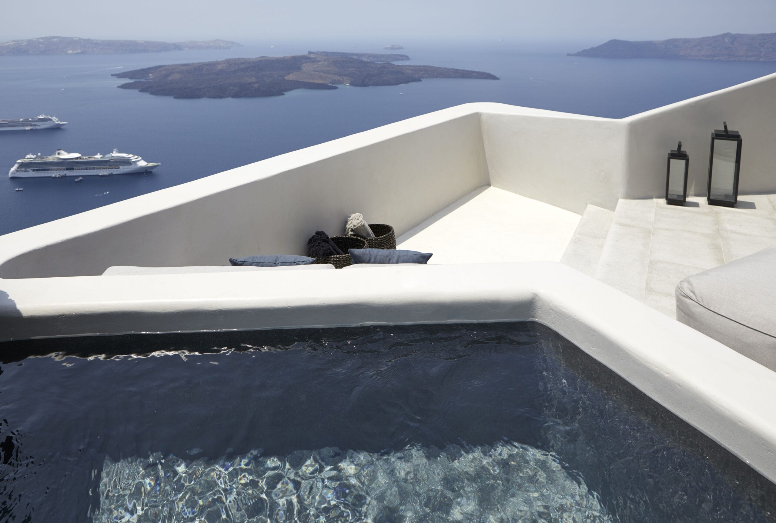 Vora Santorini private plunge pool hanging over the caldera at sunset