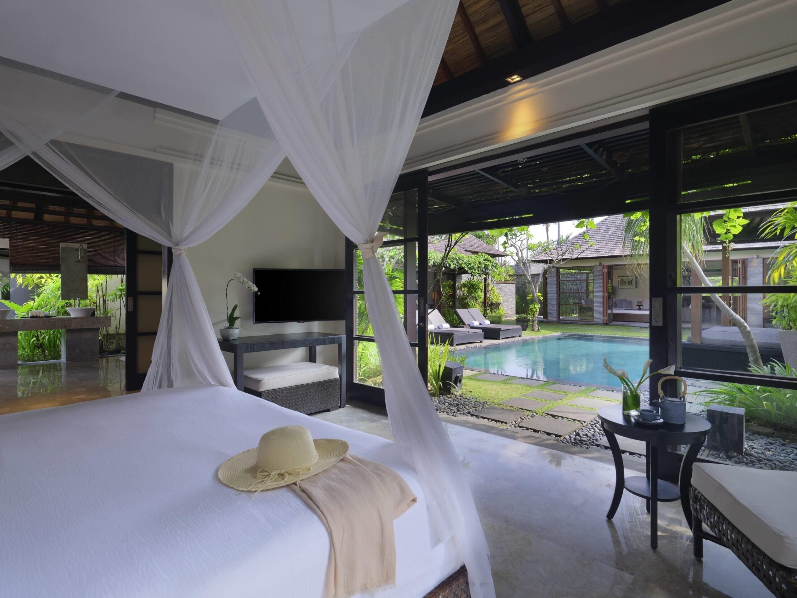 Villa bedroom opening onto the private pool at Peppers Seminyak, Bali