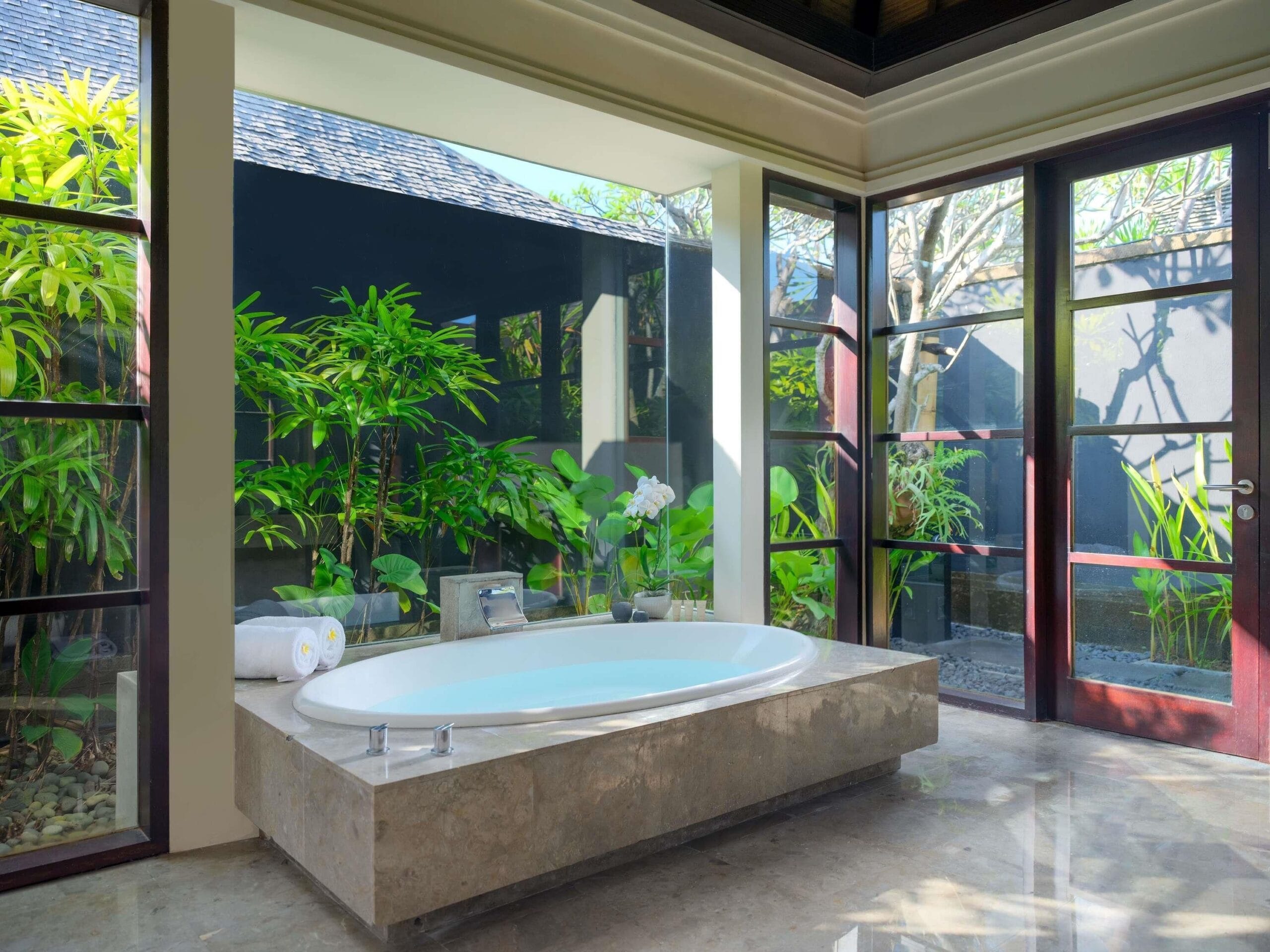 Semi-outdoor villa bathroom with deep bath at Peppers Seminyak, Bali