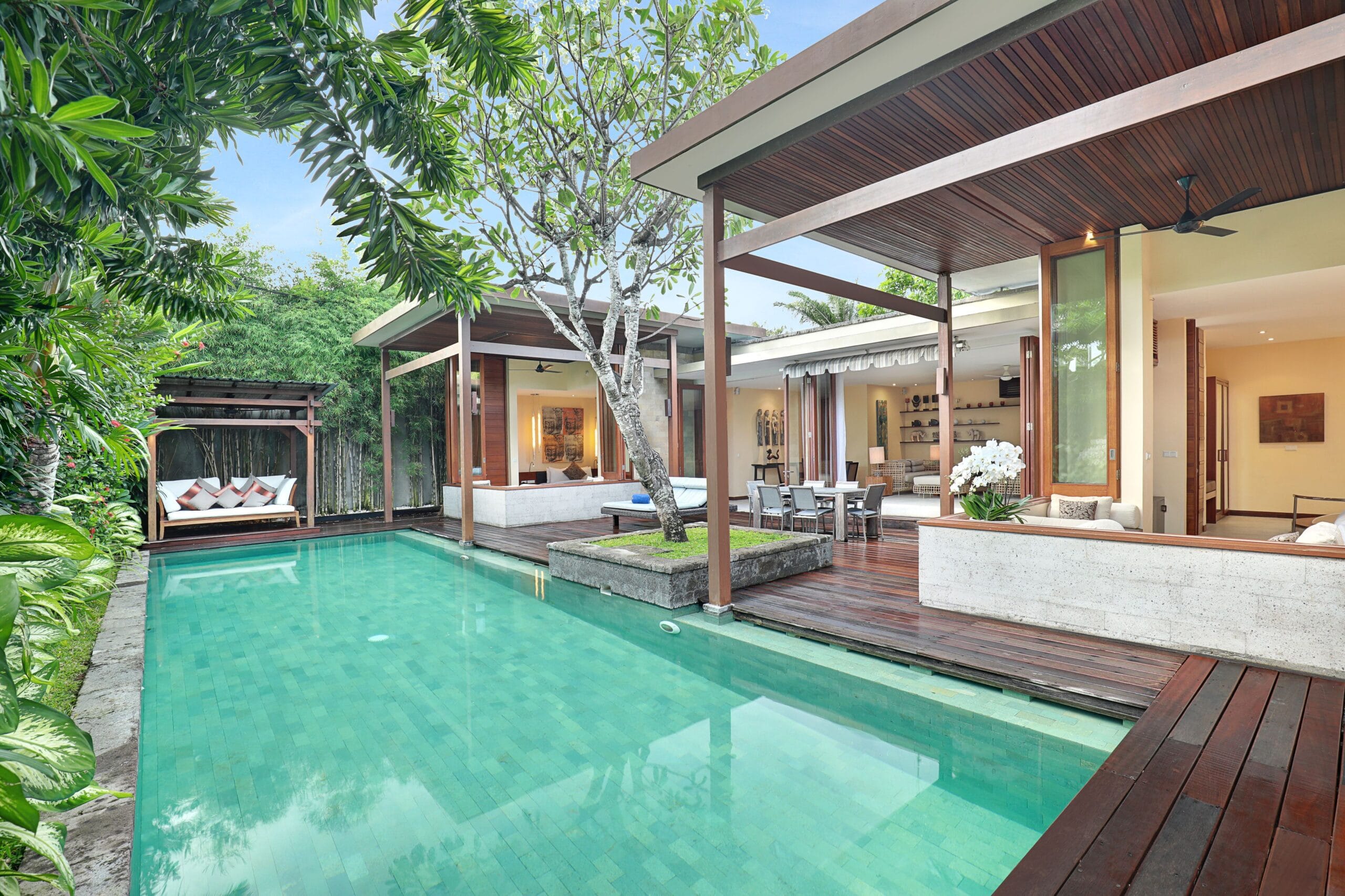 Private pool and wooden sundeck in a walled villa garden at The Elysian Boutique Villa Hotel, Seminyak