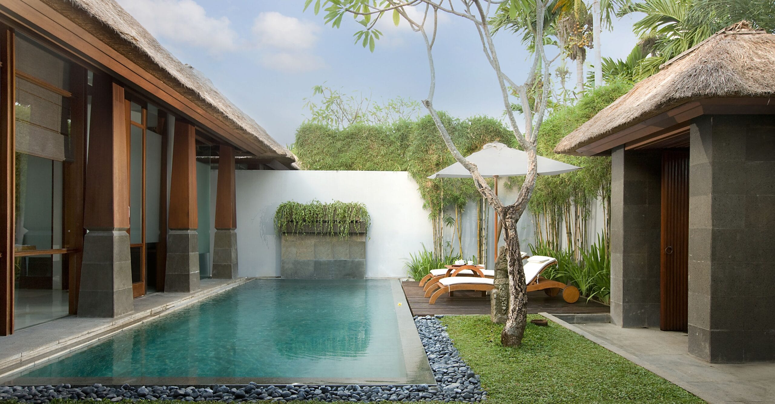 Private pool in a walled villa garden at The Kayana Seminyak, Bali