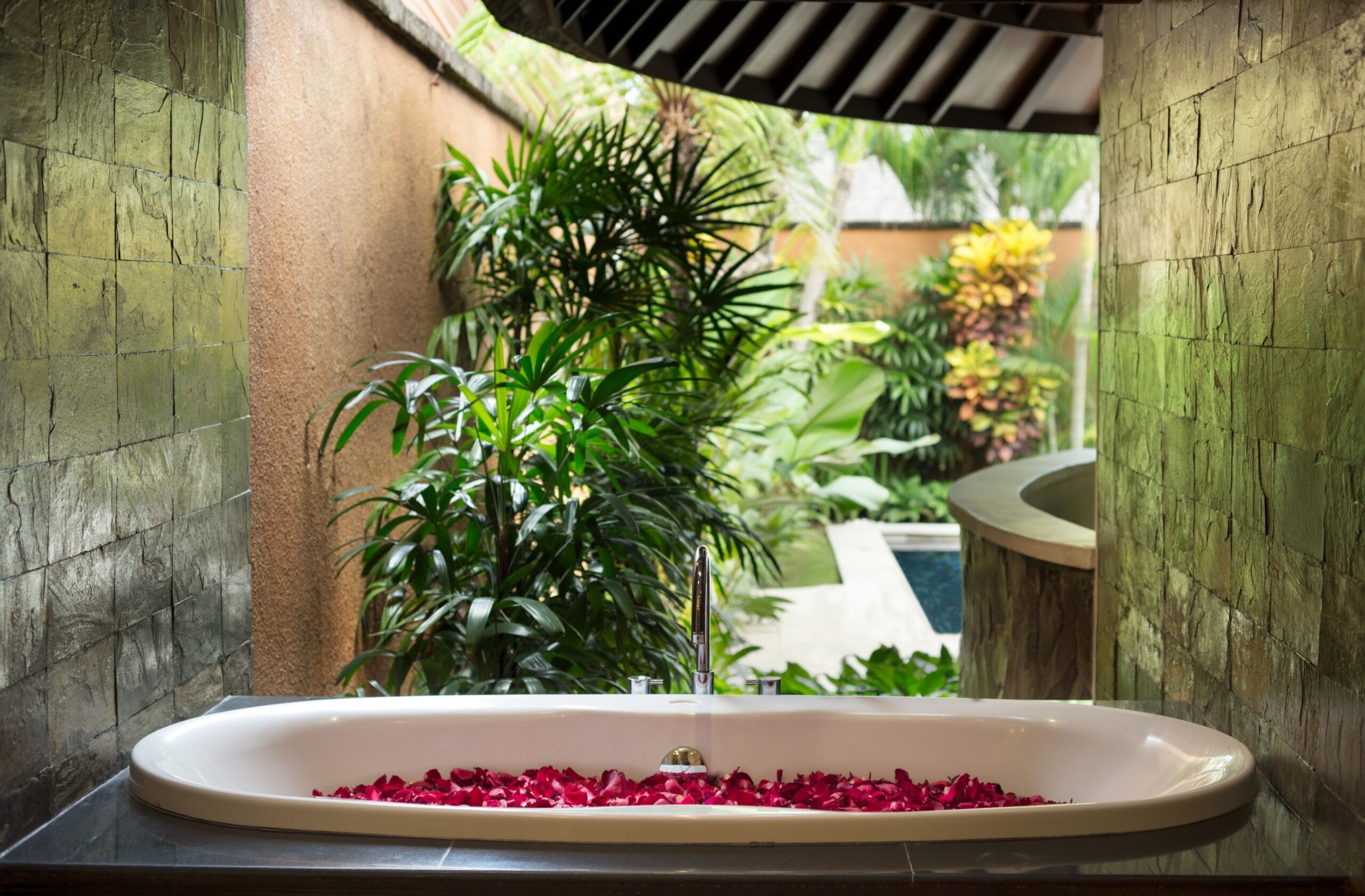 Semi open-air bathroom with freestanding bathtub at The Kunja Villas and Spa, Seminyak