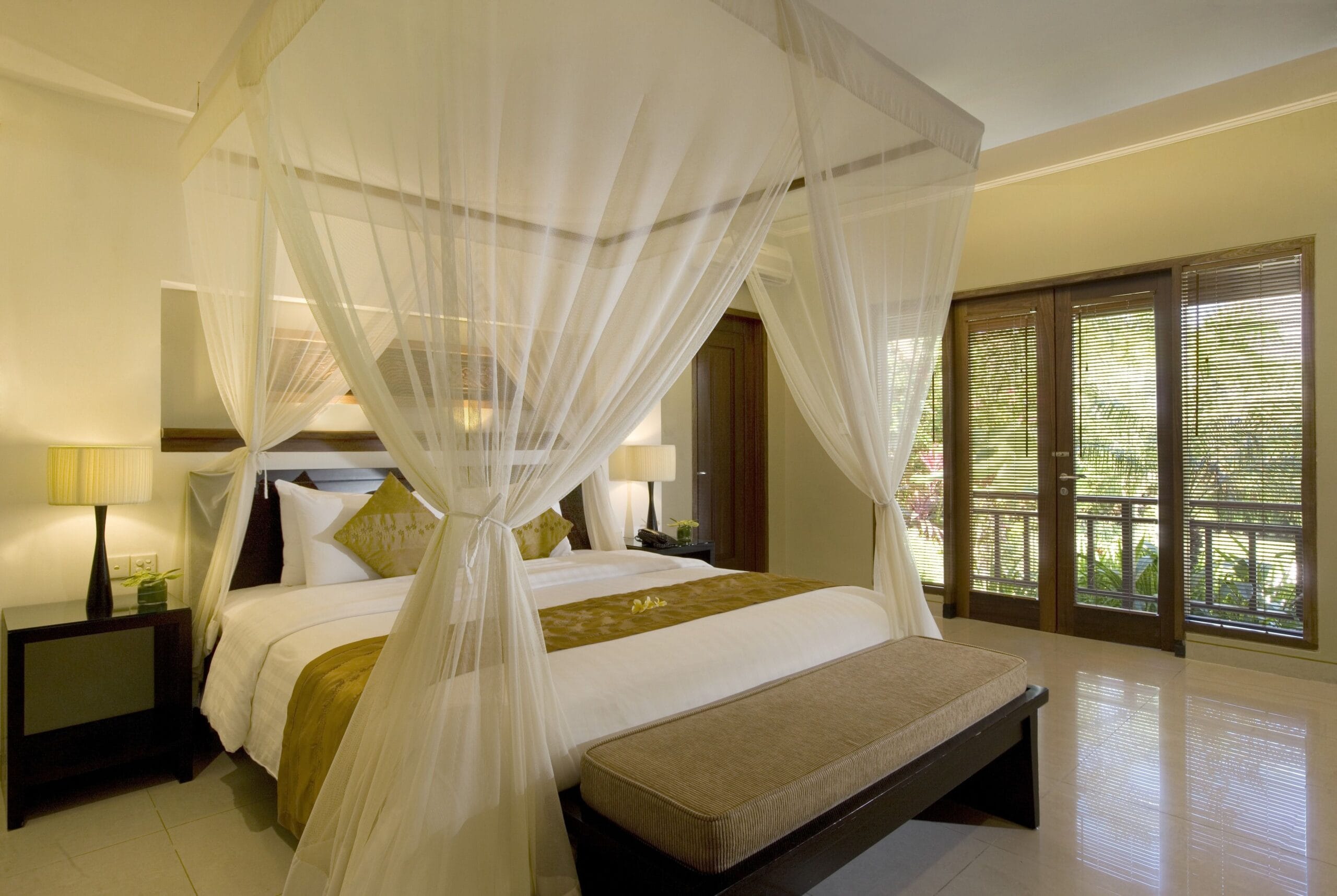 Canopy king bed looking out to the private pool at The Kunja Villas and Spa, Seminyak