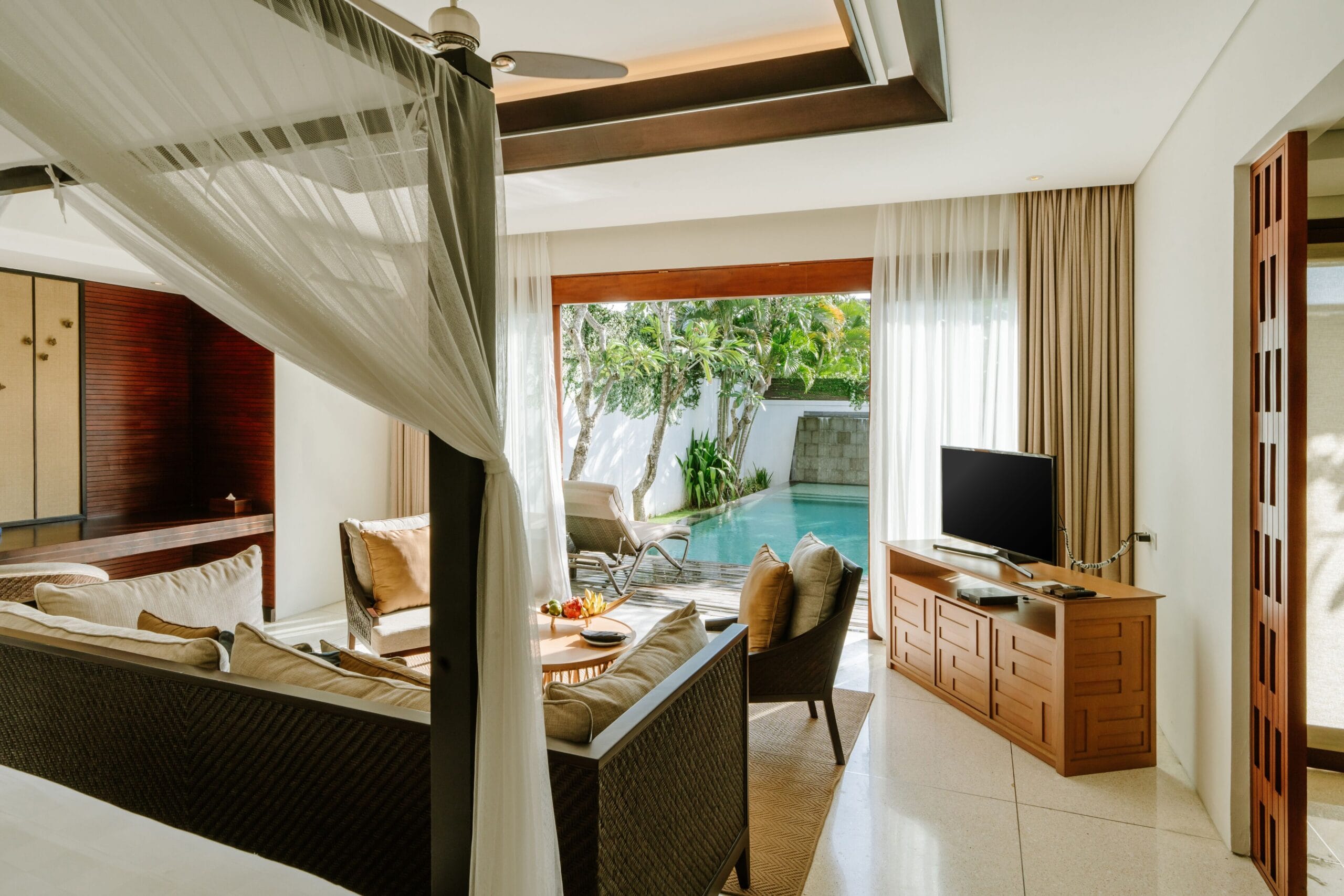 Villa interior with canopied bed and open-air living space at The Samaya Seminyak, Bali