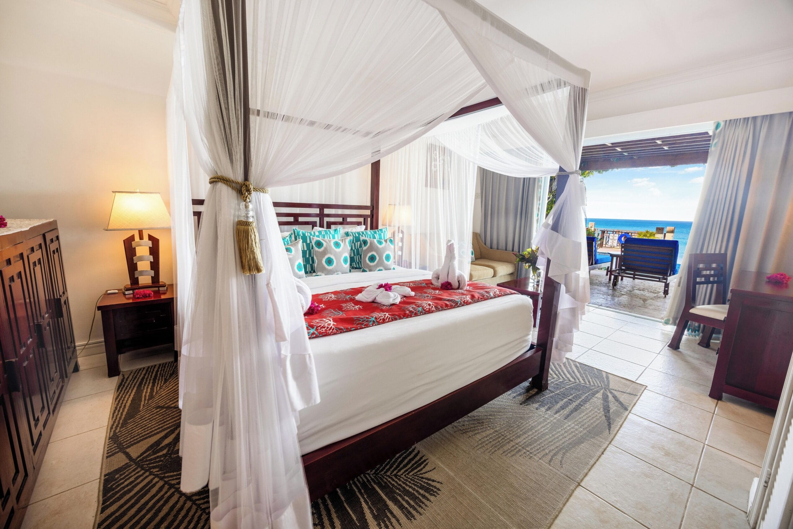 Ocean view suite interior with four-poster bed at Calabash Cove, St. Lucia
