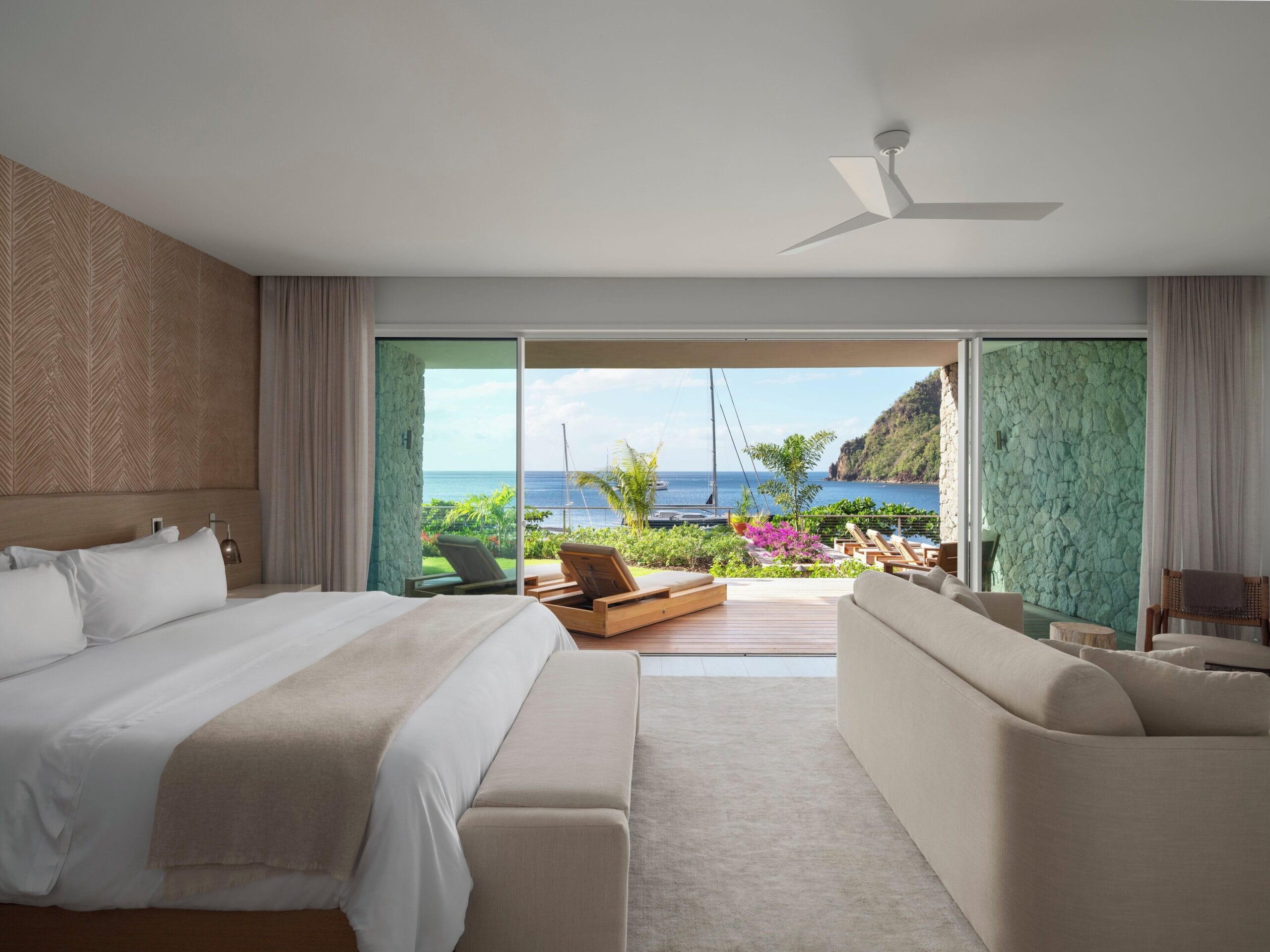 All-white oceanfront luxury suite with four-poster bed at Sugar Beach, St. Lucia