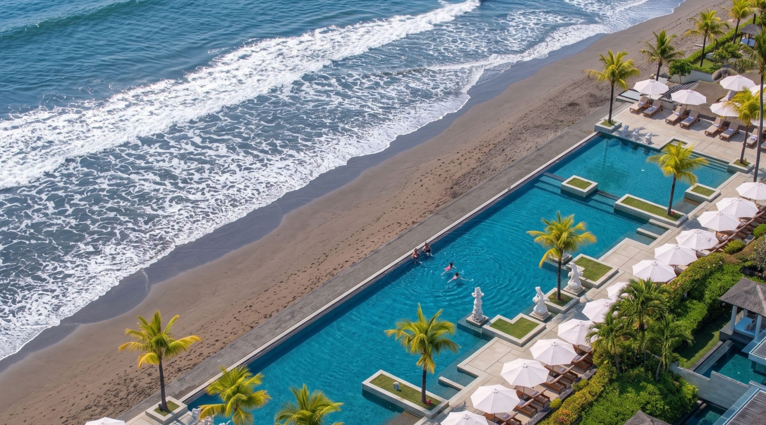 Grey volcanic sand and surf on the beach at Seminyak, Bali