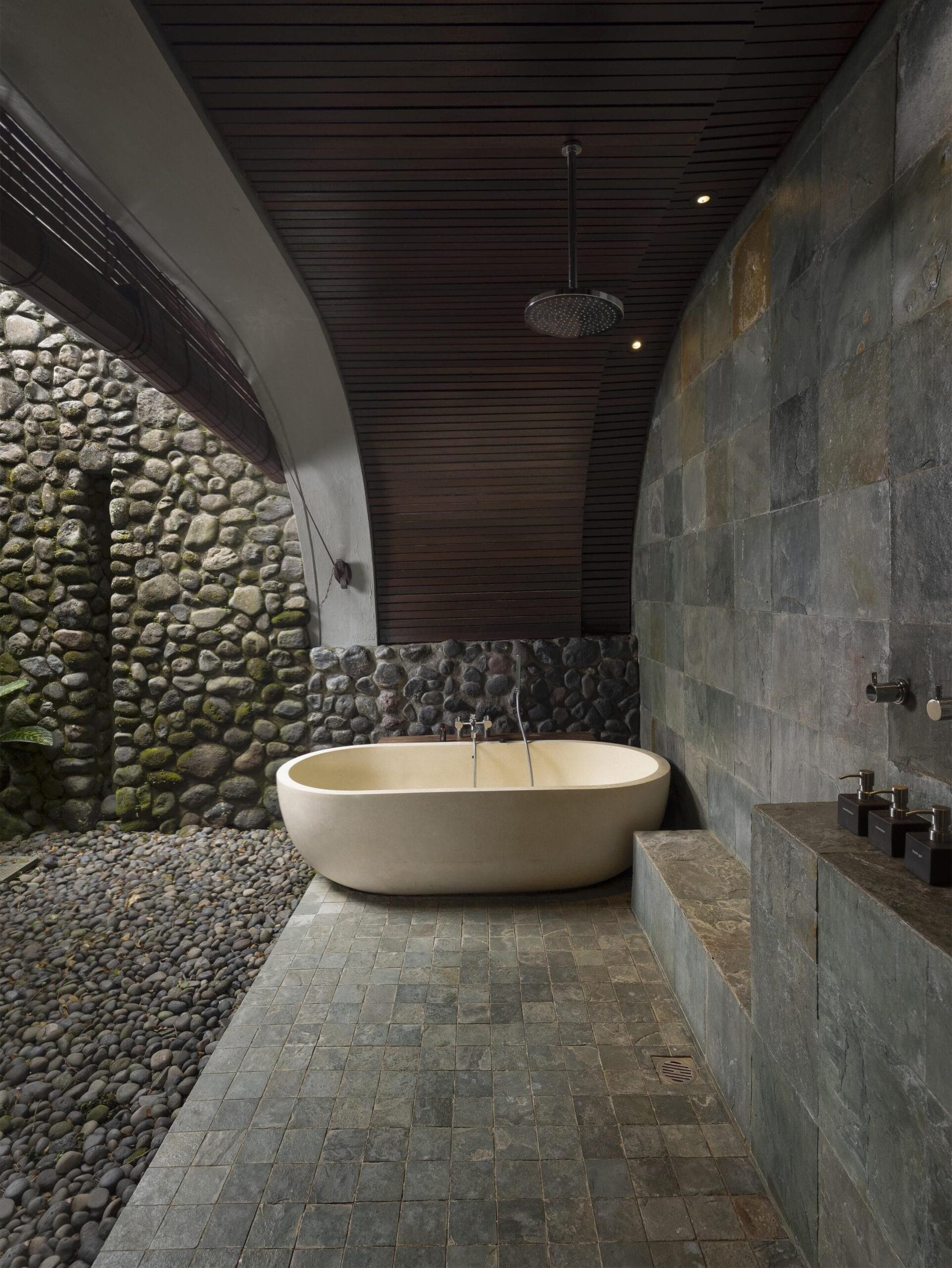 Open-air bathtub set in a lily pond at a villa at Alila Ubud, Bali