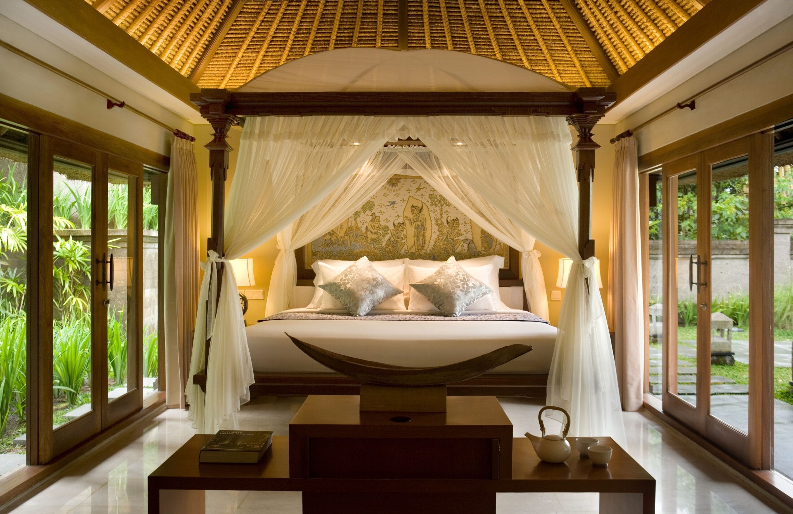 Four-poster bed in a thatched villa at Kamandalu Ubud, Bali