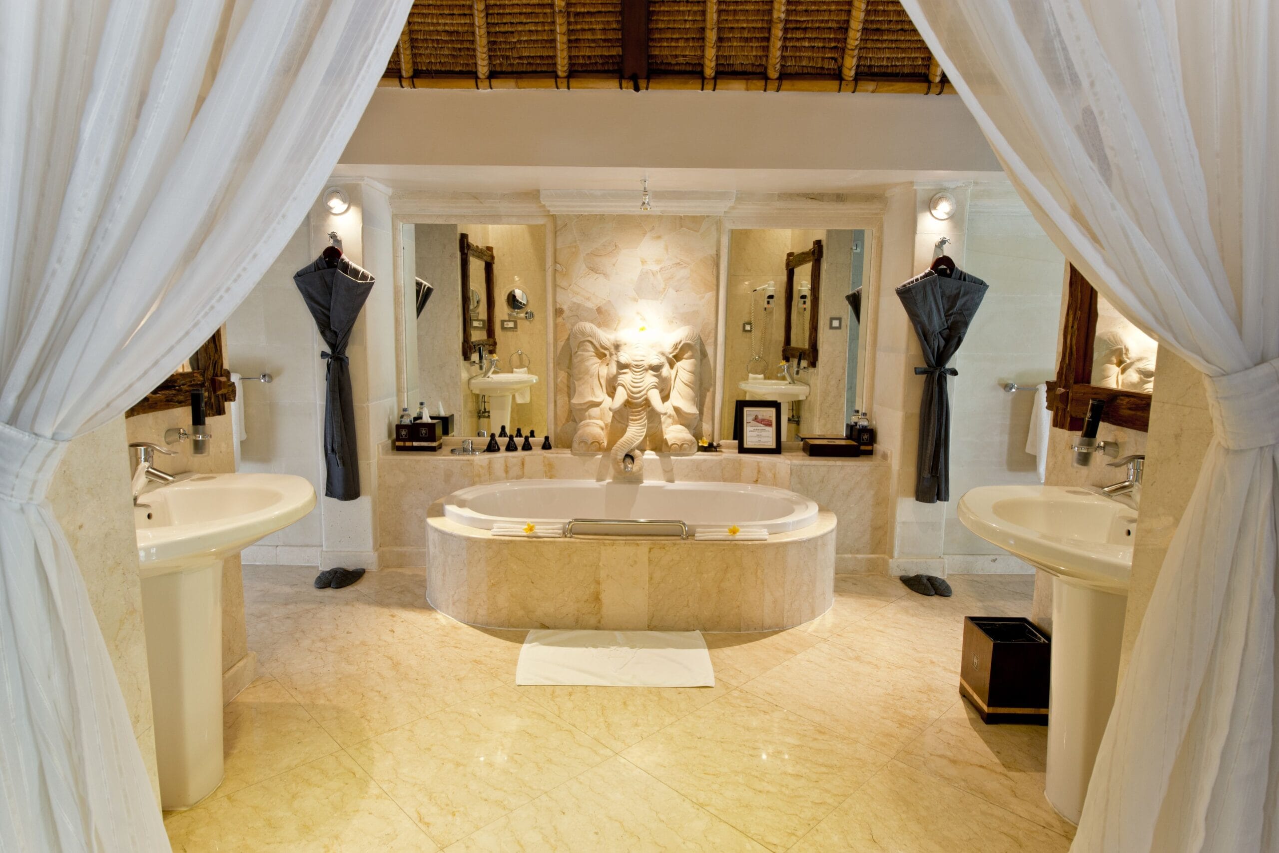 Open-plan marble bathroom with freestanding soaking tub at Viceroy Bali, Ubud